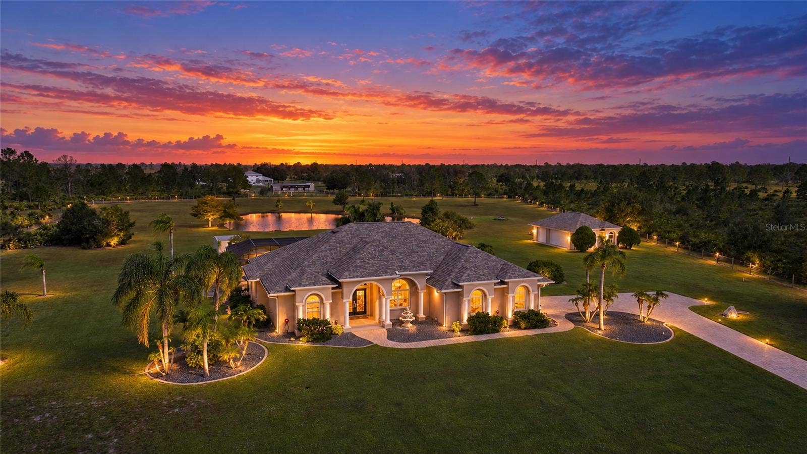 Photographer enhanced lighting - Property is Gorgeous!  Secured, Gated Entry with Long, Paver Drive. 5 Car Garage, Pond, Fenced, 6.39 Acres, Shed with Electric and Patio,  Equestrian Trails