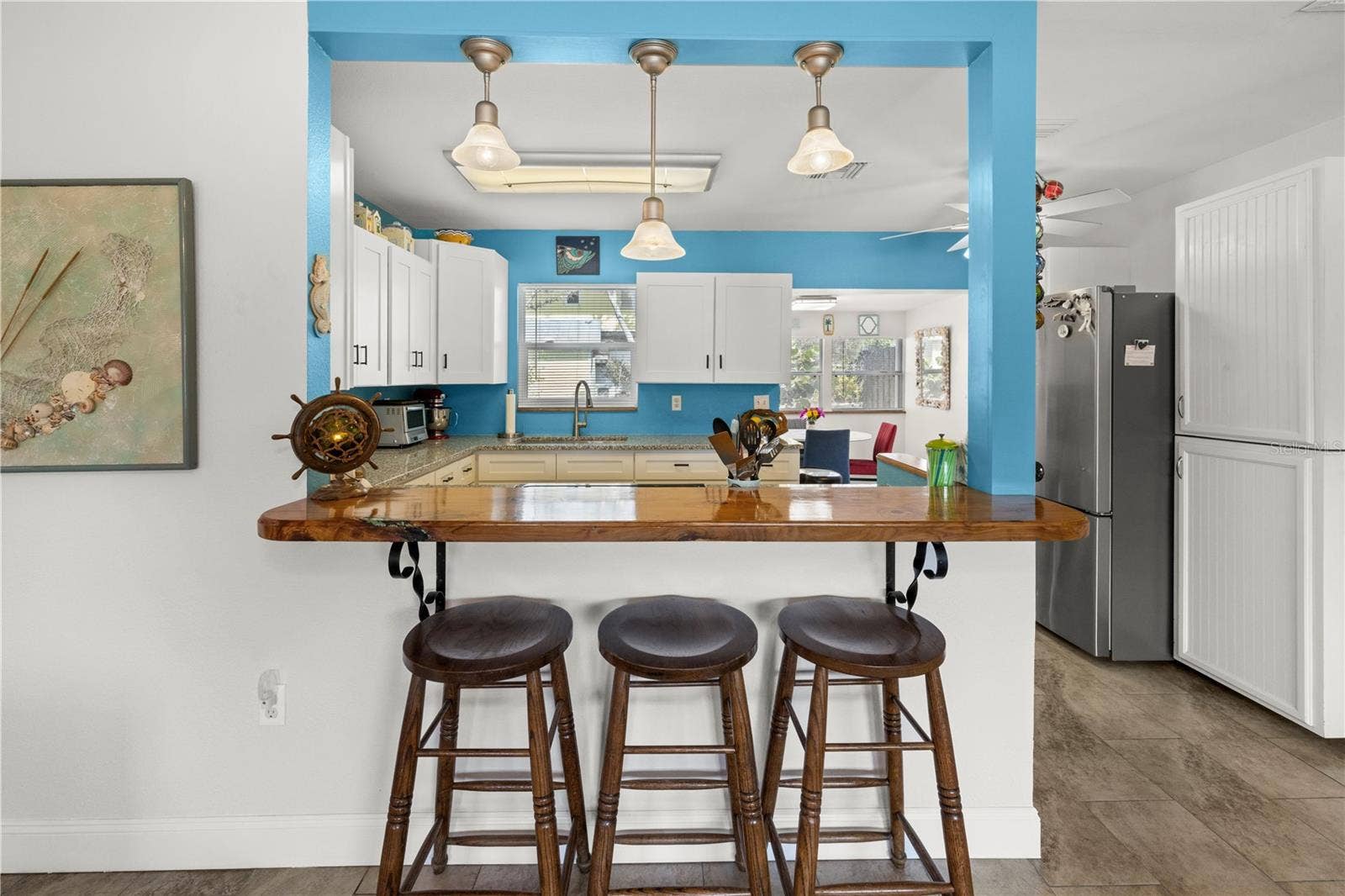7035 DUKE STREET, Englewood, FL 34224 The pass through counter connects the living room to the kitchen and the dining area. It's a great open concept that allows conversations while you cook!