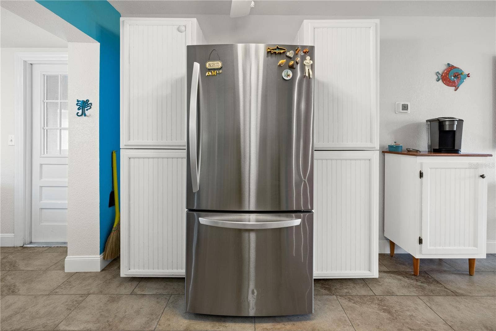 7035 DUKE STREET, Englewood, FL 34224 In addition to the cabinets in the kitchen, there is generous cabinet storage on the refrigerator side.