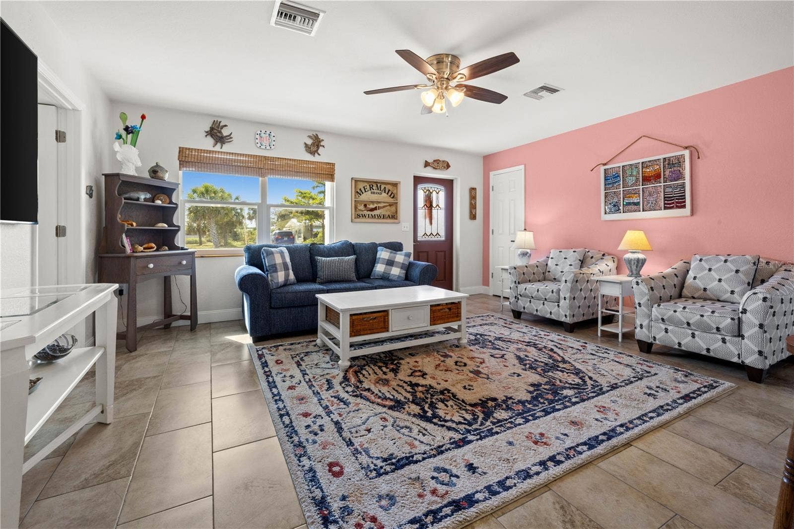 7035 DUKE STREET, Englewood, FL 34224 Throughout the home are well maintained ceramic tile. The living room is bright and spacious.