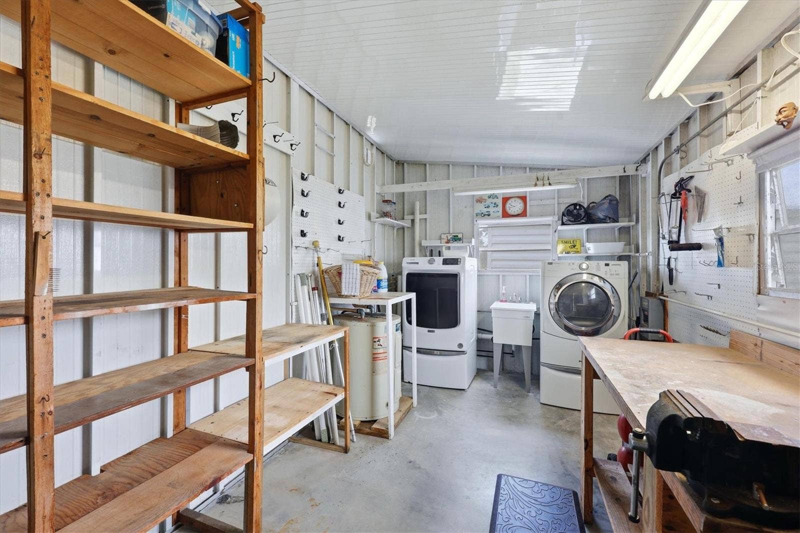 240 VIA DE LUNA, Englewood, FL 34224 Enclosed Laundry room with workbench and storage