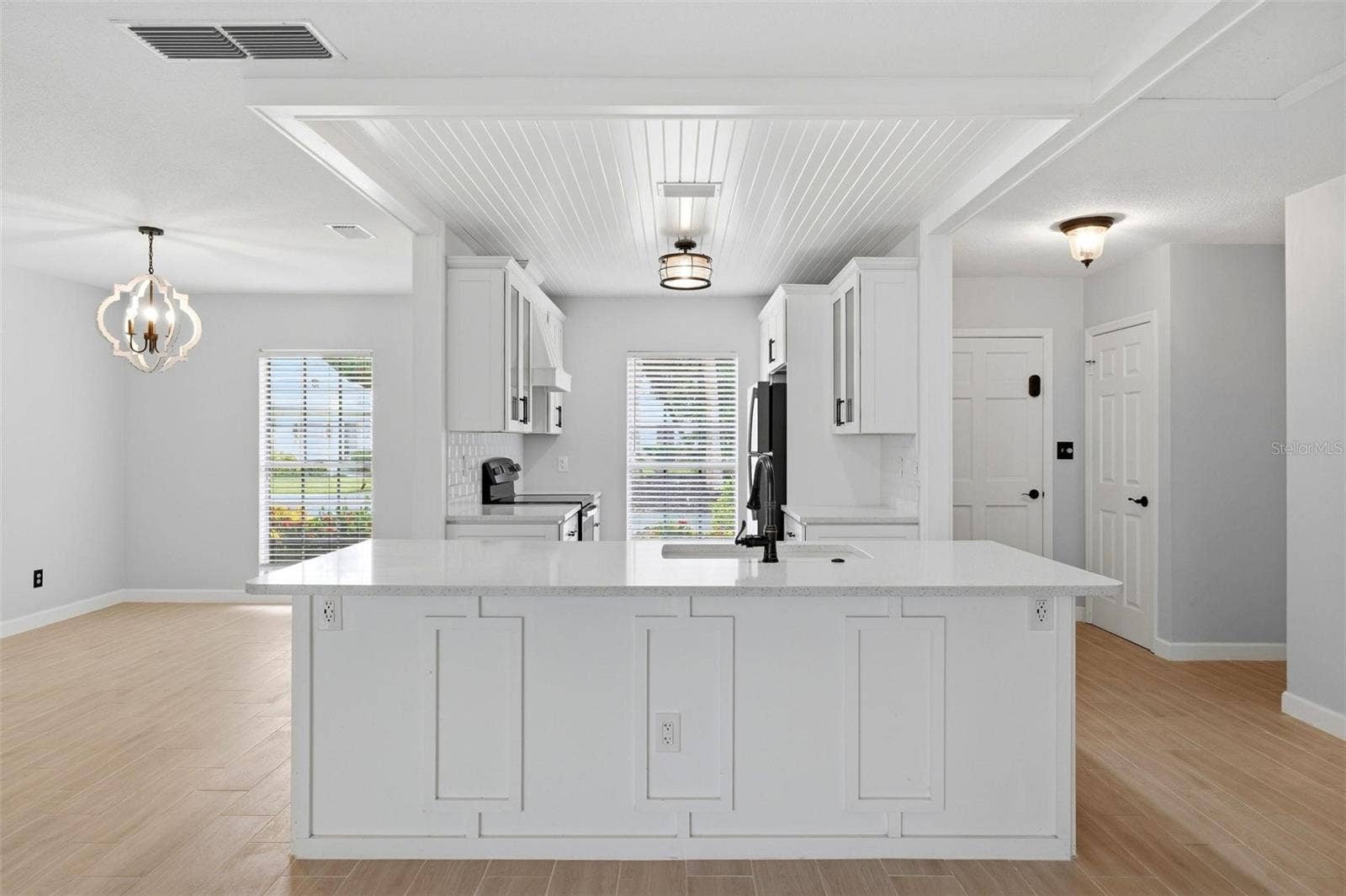 The large breakfast bar divides kitchen from the living area.  Plenty of room for bar stools for quick meals and extra counter space.