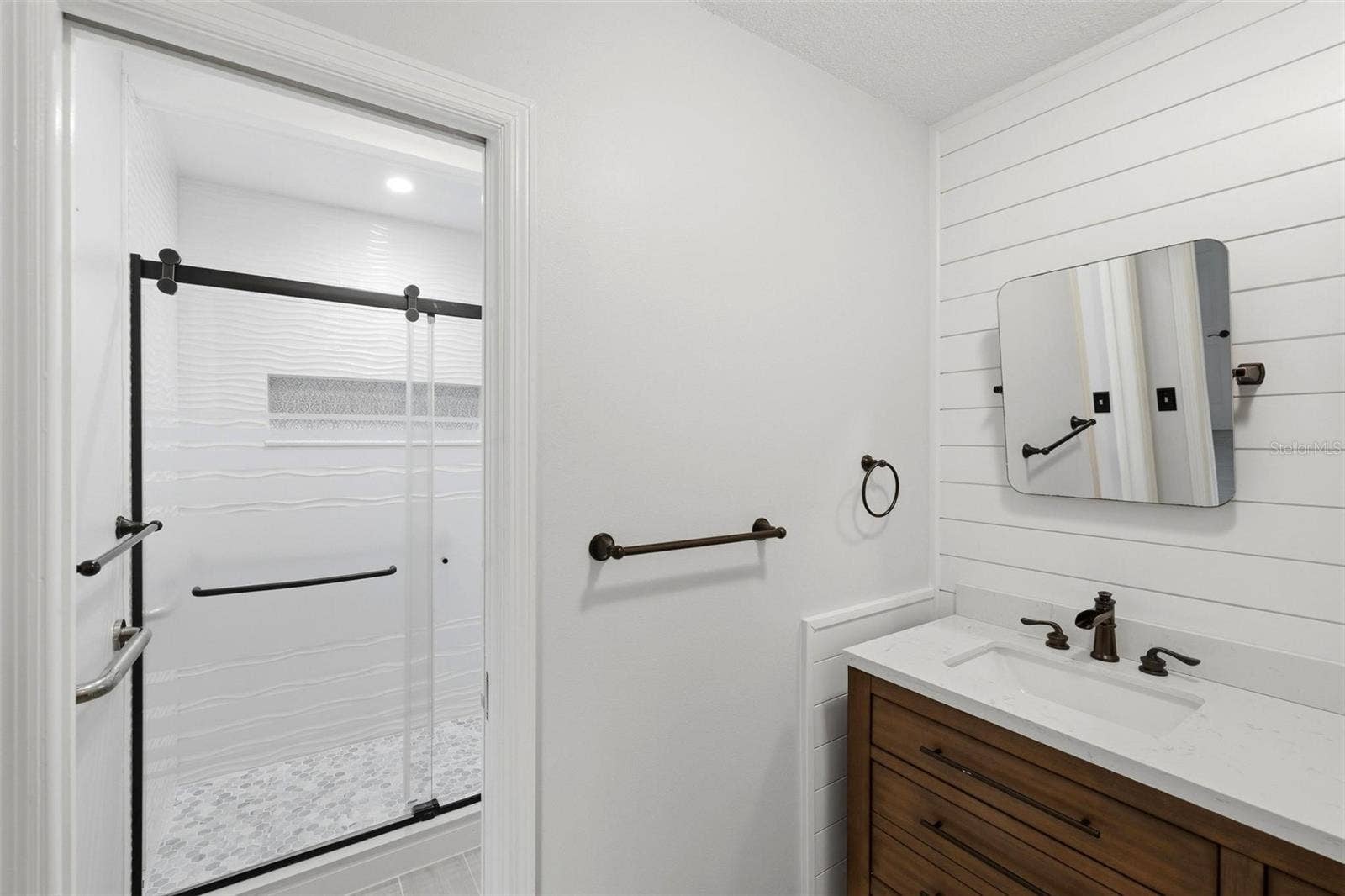 Separate room in primary bathroom for walk-in shower and toilet.
