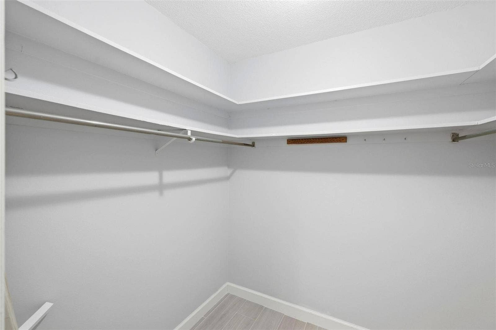 Large walk-in closet for primary bedroom.