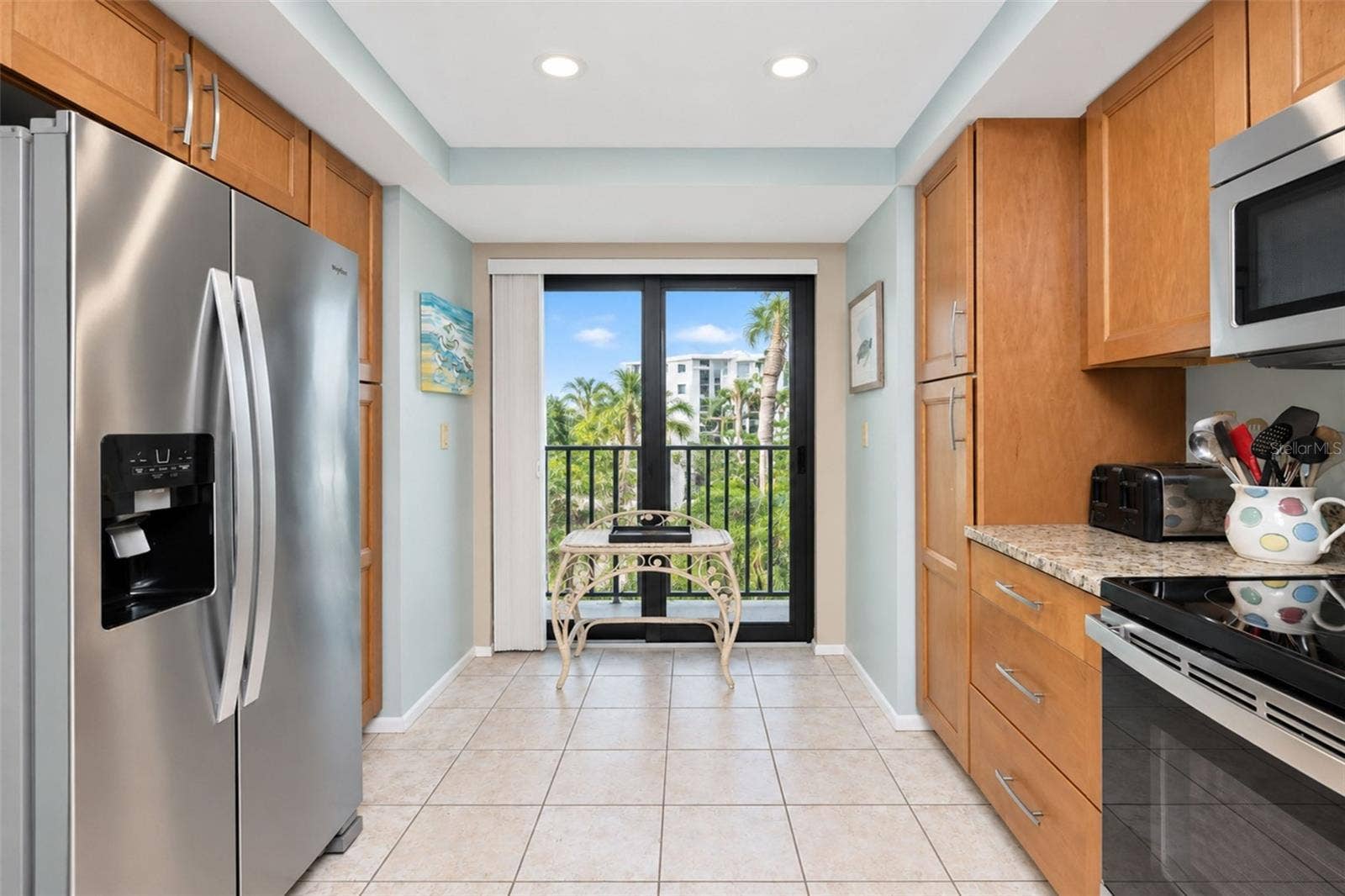 2950 N BEACH ROAD, #A321, Englewood, FL 34223 The kitchen has a stainless steel double door Whirlpool refrigerator and a French balony.