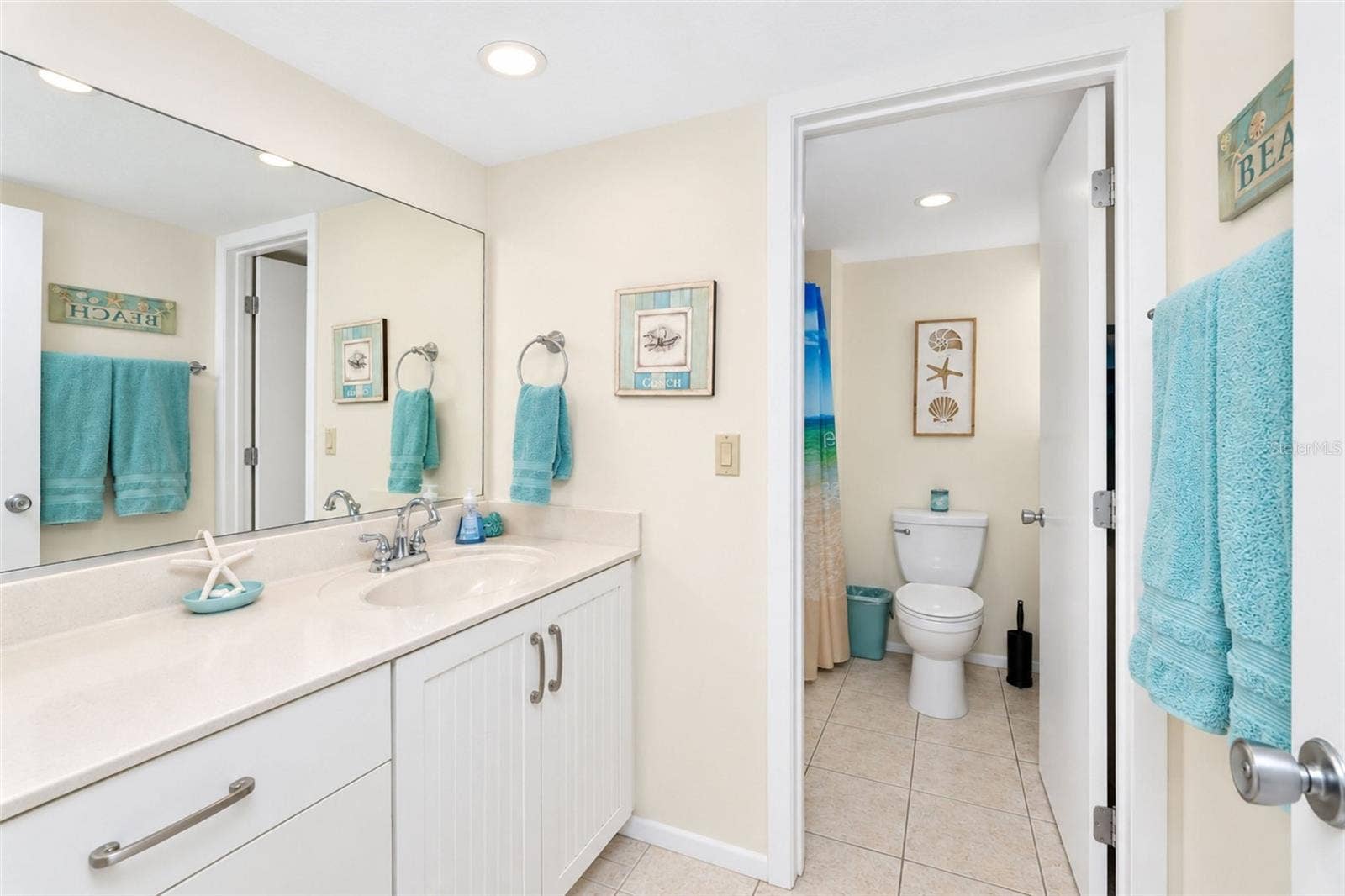2950 N BEACH ROAD, #A321, Englewood, FL 34223 The guest bathroom features tiled flooring and an updated solid surface countertop vanity.