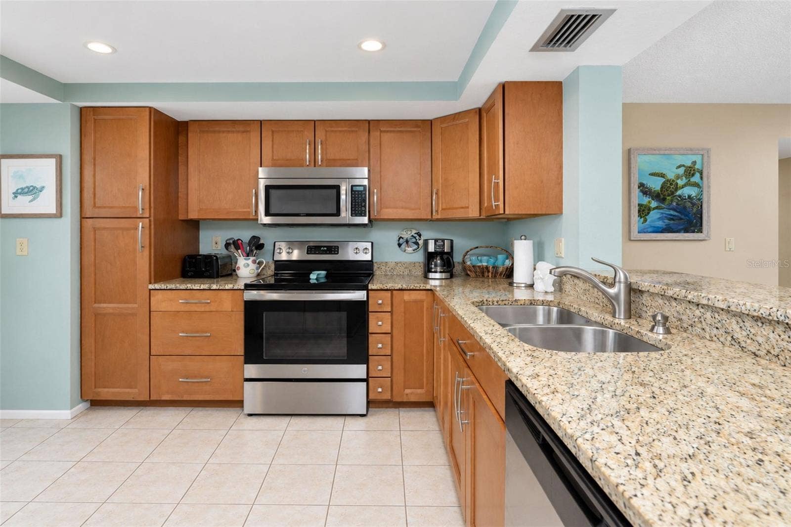 2950 N BEACH ROAD, #A321, Englewood, FL 34223 The kitchen features a GE stove, Frigidaire dishwasher and a Whirlpool microwave...all stainless steel!