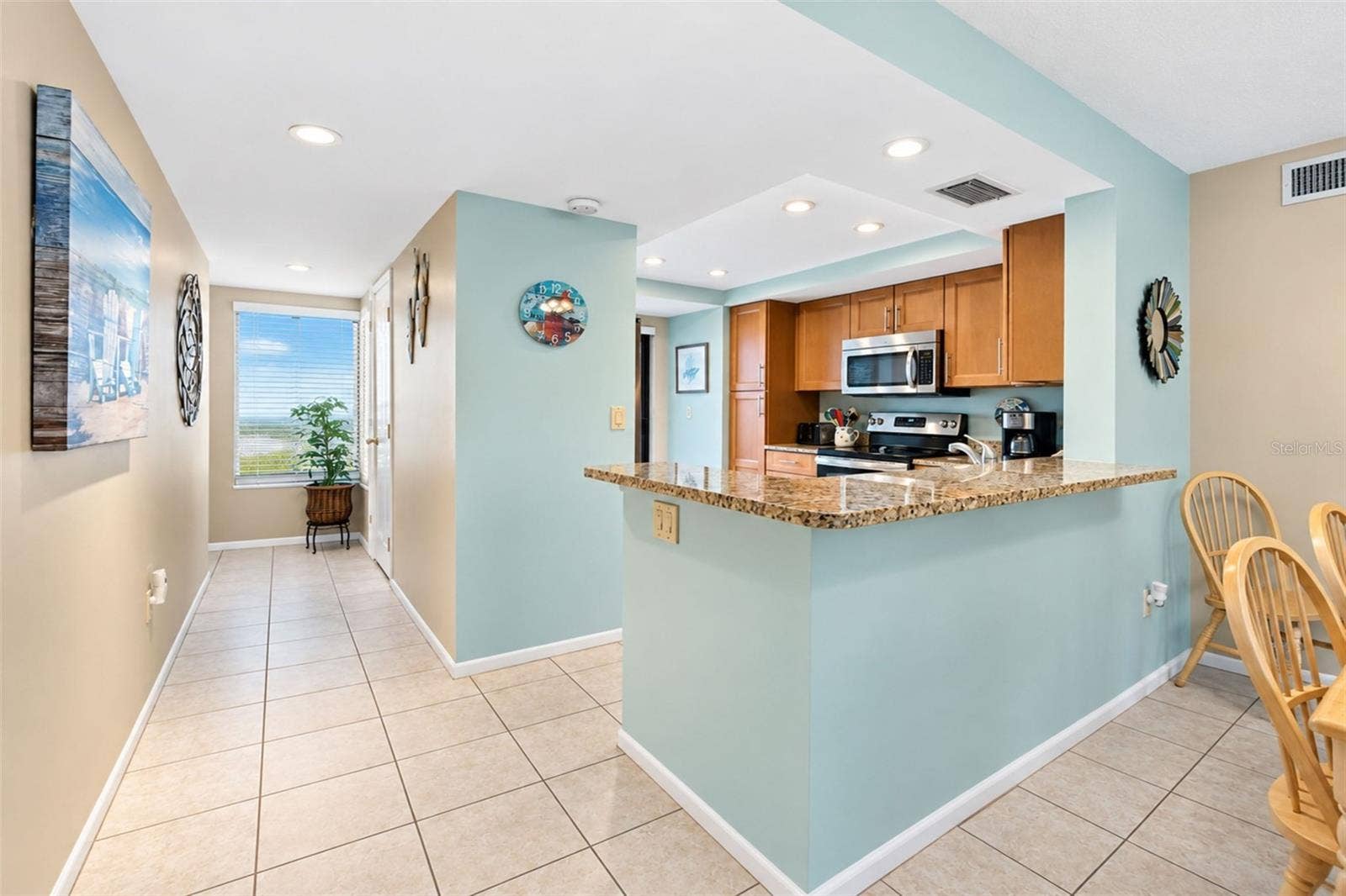 2950 N BEACH ROAD, #A321, Englewood, FL 34223 The kitchen features tiled flooring and a high top breakfast bar.