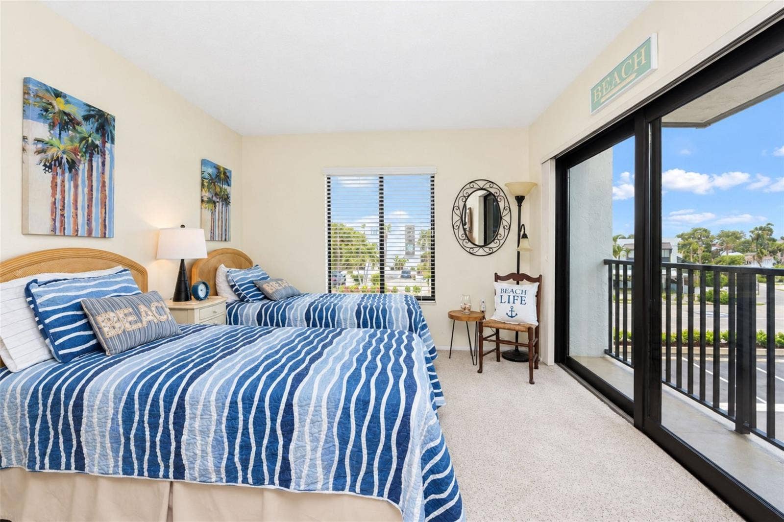 2950 N BEACH ROAD, #A321, Englewood, FL 34223 The guest bedroom has carpeted flooring and impact sliding glass doors to the French balcony.