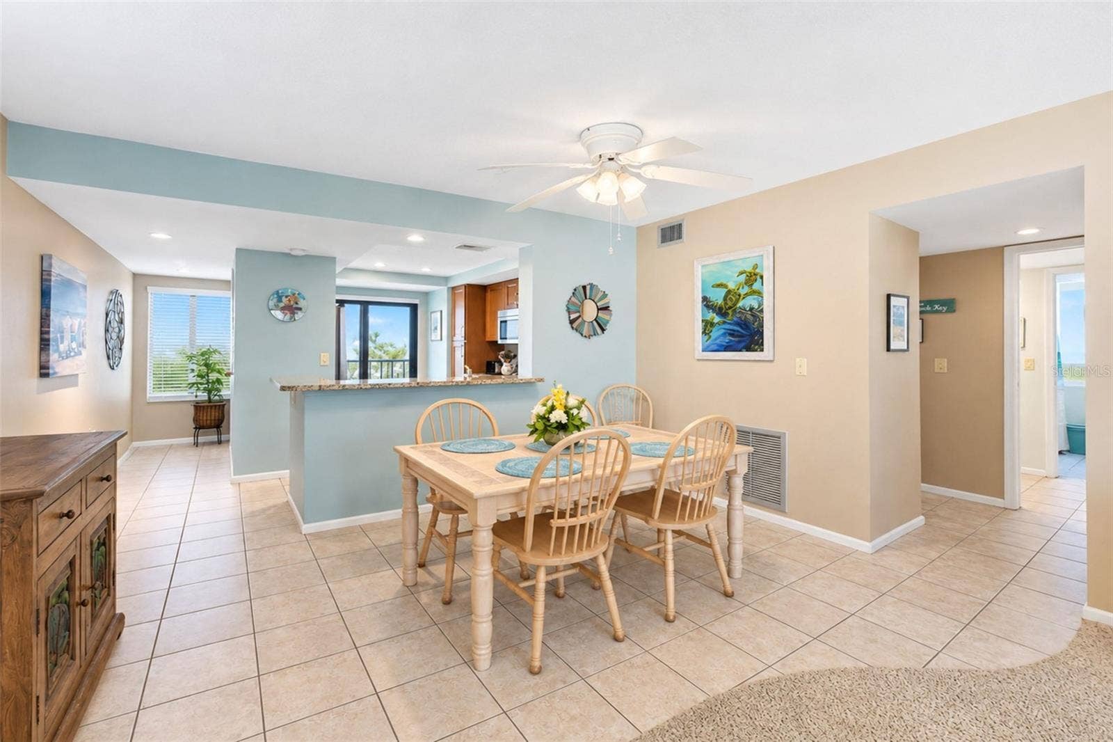 2950 N BEACH ROAD, #A321, Englewood, FL 34223 The dining room has tiled flooring and a ceiling fan with light.
