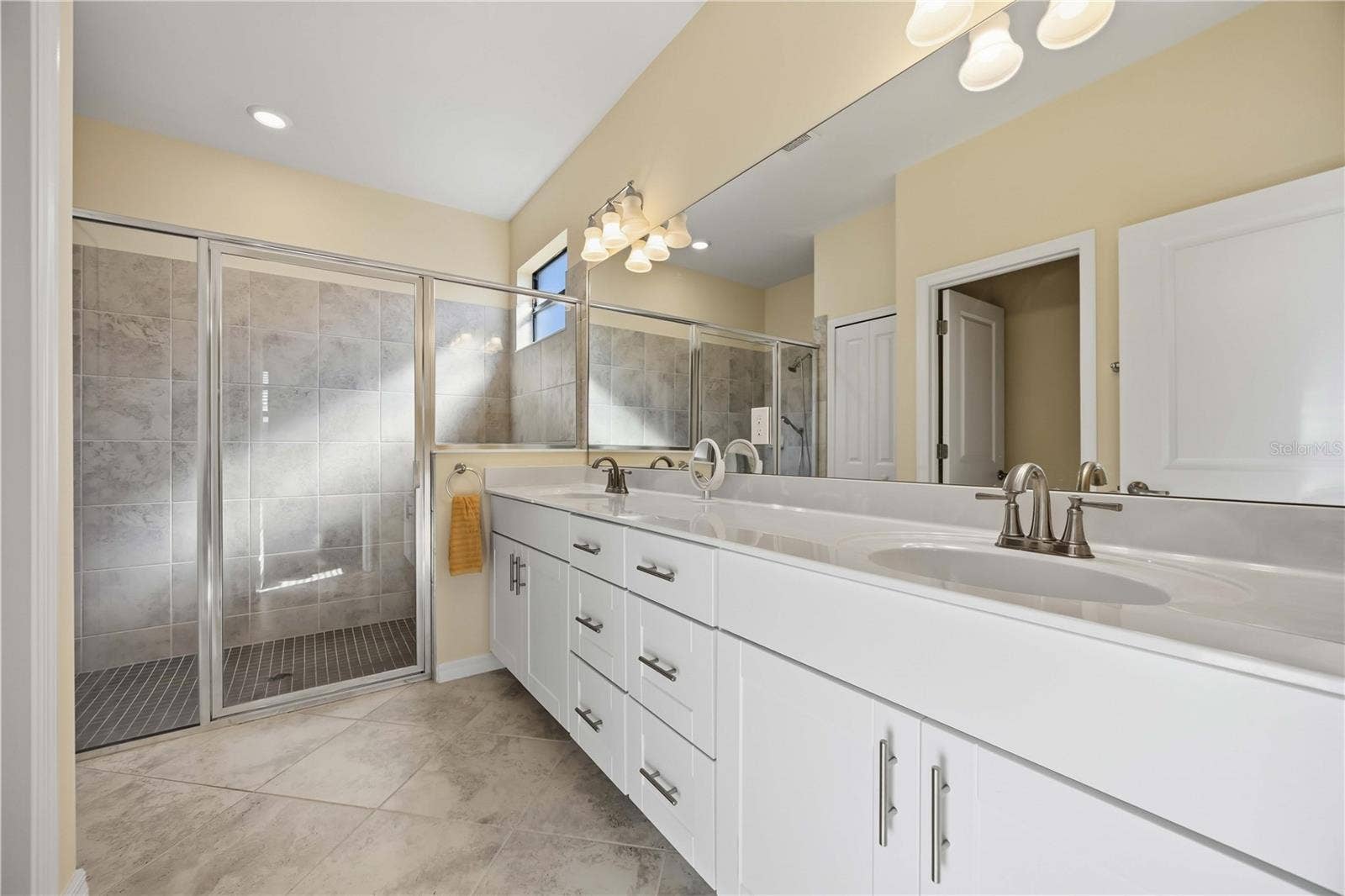 15945 HONEY SUCKLE STREET, Port Charlotte, FL 33953 Owner's Bath with spacious tile shower and dual vanities