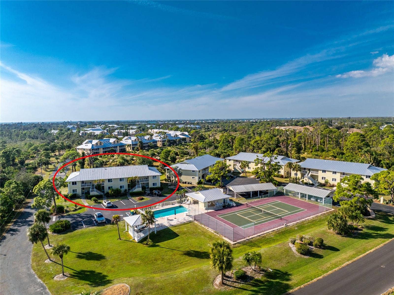 6600 GASPARILLA PINES BOULEVARD, #14-103, Englewood, FL 34224 Aerial #3 - notice that you are across the parking area from the clubhouse & pool and tennis/pickleball courts!