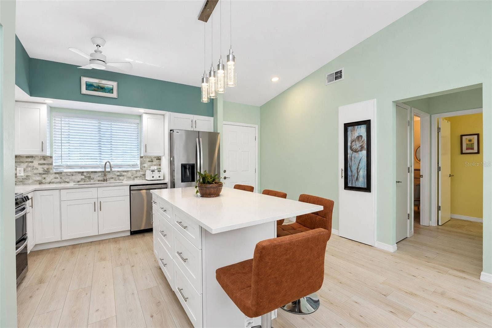 6468 HAMLET DRIVE, #B, Englewood, FL 34224 The kitchen features white cottage-style cabinetry, a decorative backslash and QUARTZ countertops.