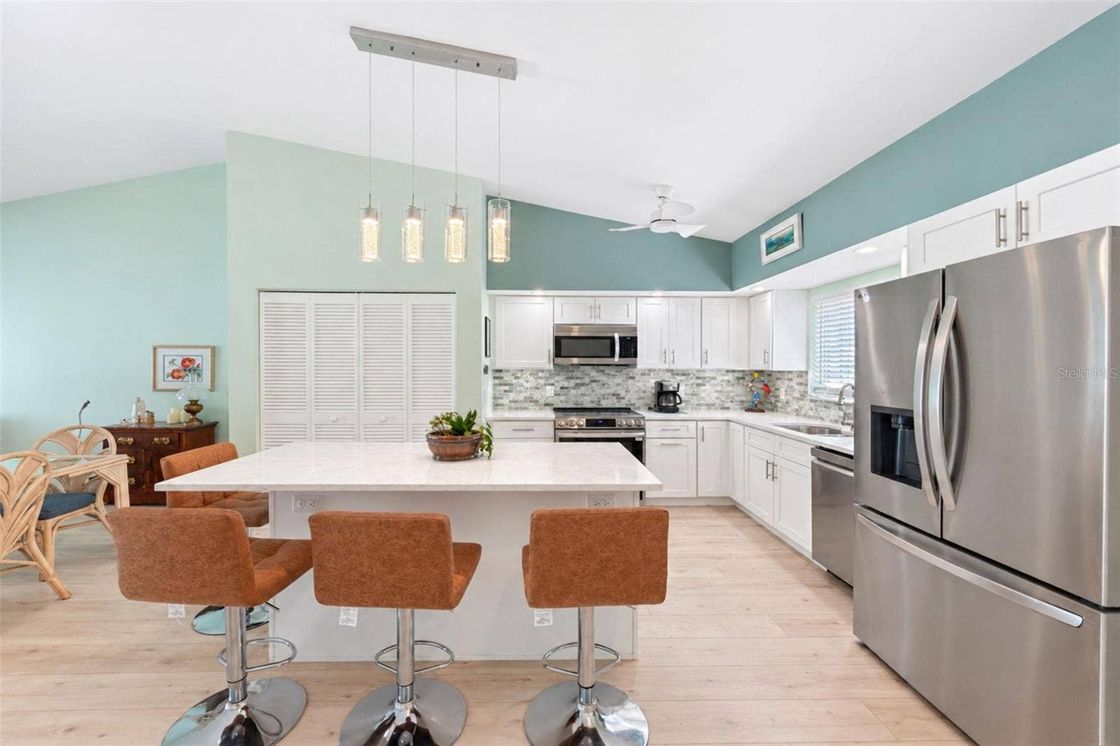 6468 HAMLET DRIVE, #B, Englewood, FL 34224 The kitchen island provides extra seating, beautiful pendant lighting and extra cabinetry.