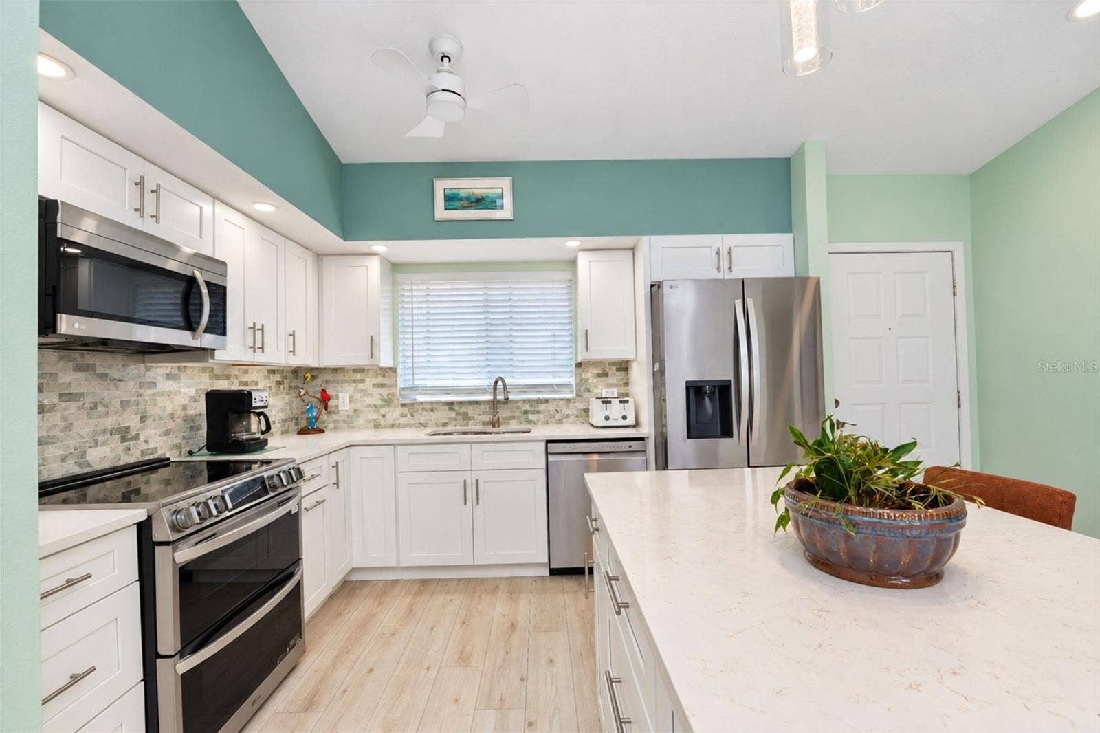 6468 HAMLET DRIVE, #B, Englewood, FL 34224 The gorgeous kitchen features an all stainless steel LG appliance package including a French door refrigerator, dishwasher, microwave and range with double ovens & a built-in air fryer.