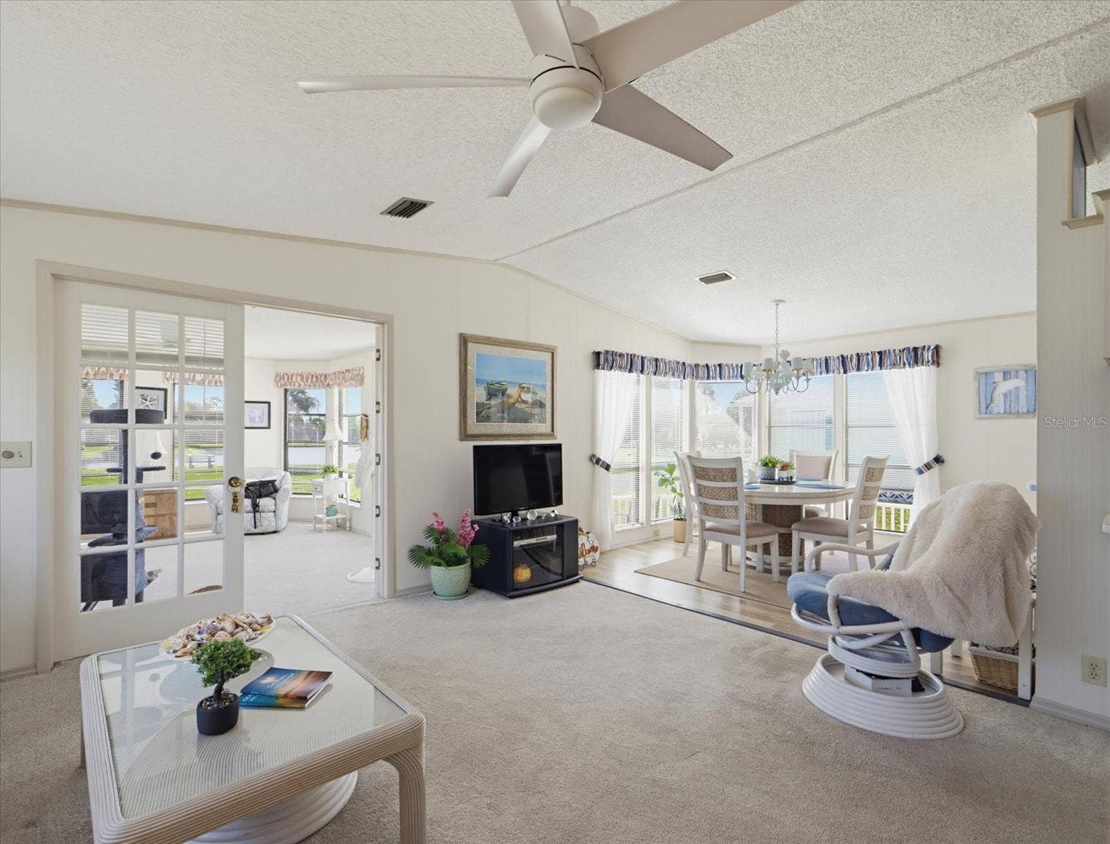 VIEW OF THE LIVING ROOM, FLORIDA AND DINING AREA.