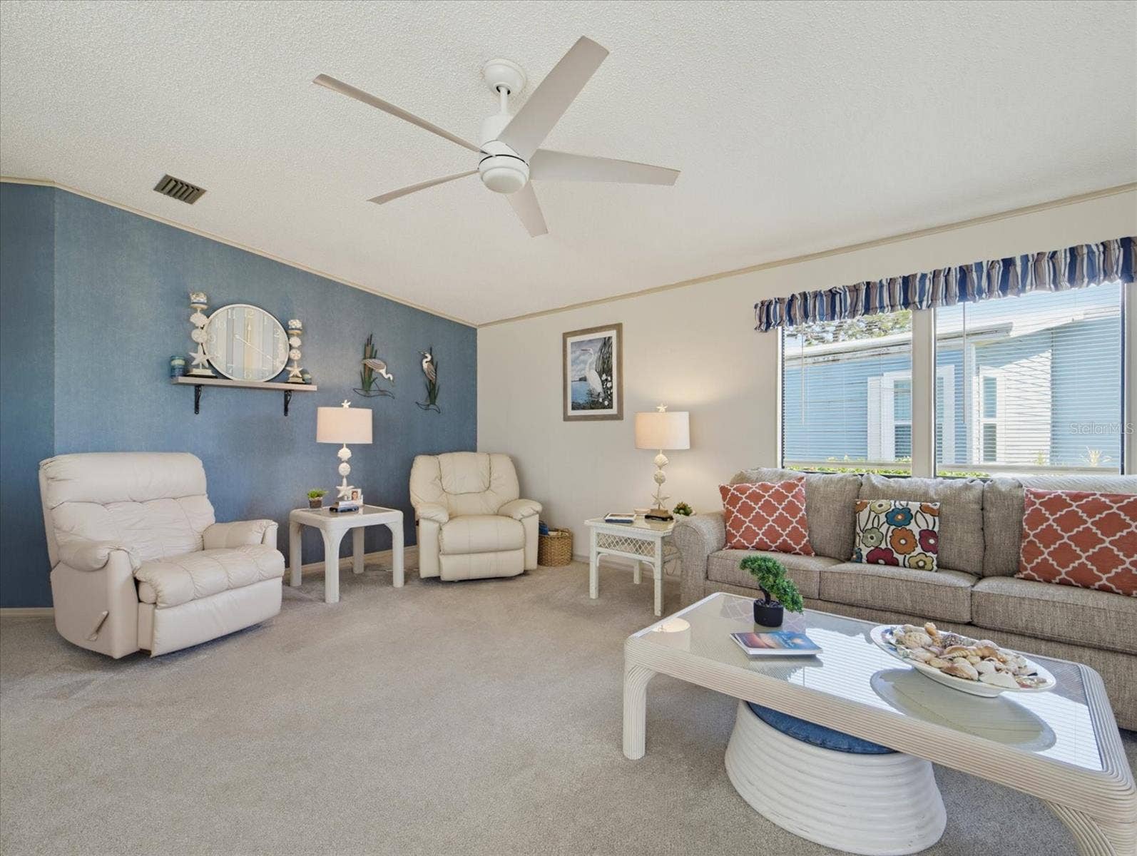 LIVING ROOM HAS CARPET AND UPDATED FAN.