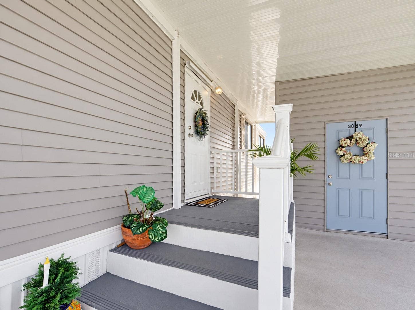 STEPPING BACK OUTSIDE. THE FRONT ENTRANCE IS COVERED. PLUS A NICE SIZE STORAGE BUIDLING.