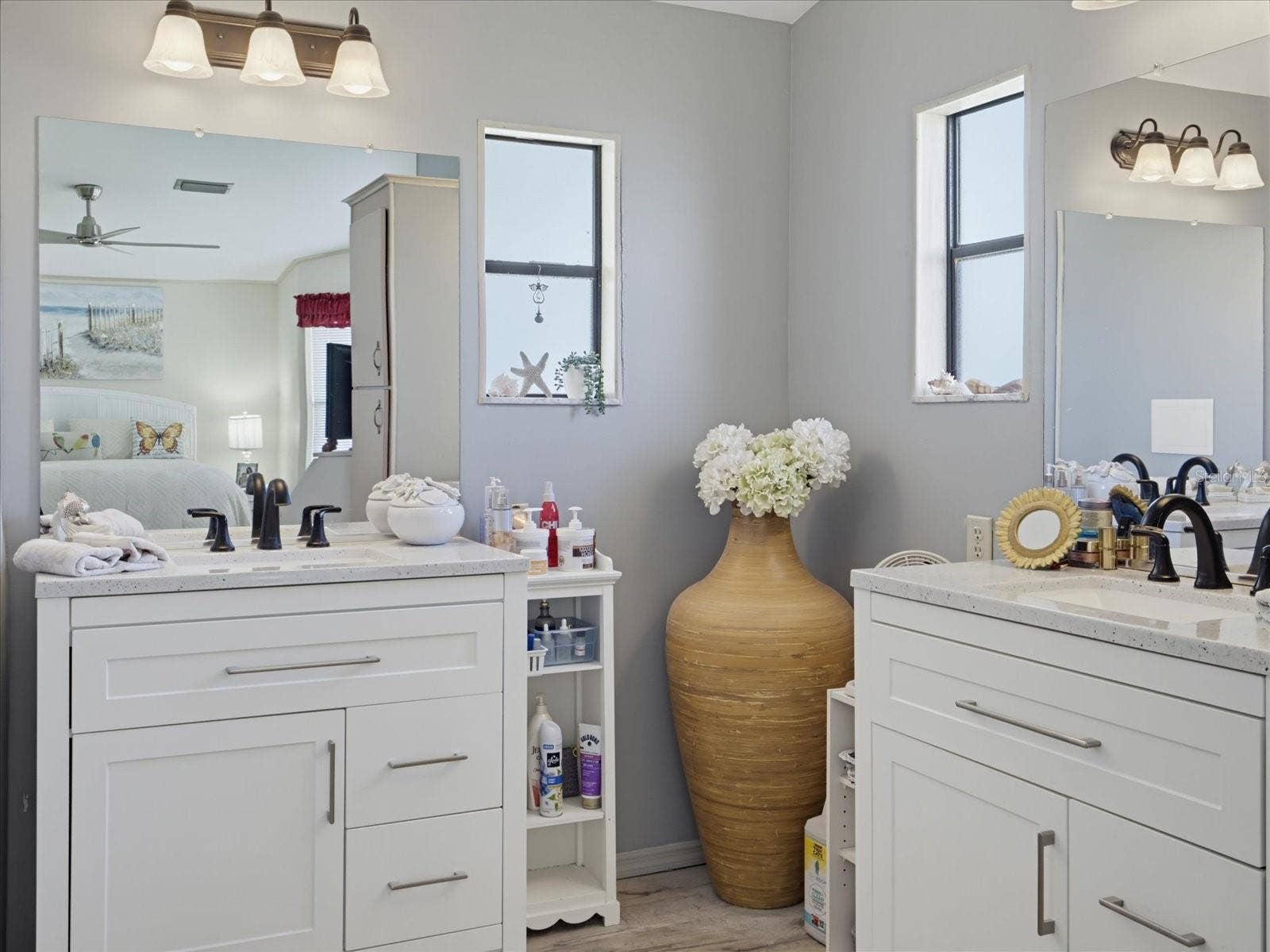 ANOTHER VIEW OF THE VANITY AREA IN THE PRIMARY BATHROOM. THERE IS A SEPARATE WATER CLOSET THAT HAS A WALK-IN SHOWER AND COMMODE.