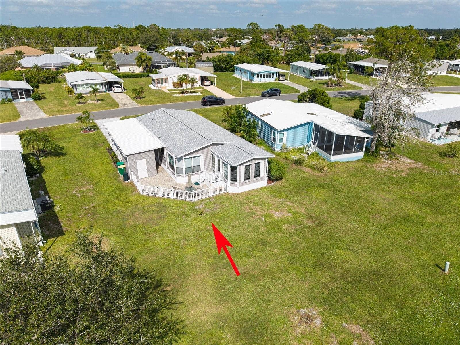 VIEW OF THE BACKYARD, PATIO AND STORAGE BUILDING. EASY ACCESS TO THE FLORIDA ROOM FROM THE PATIO.