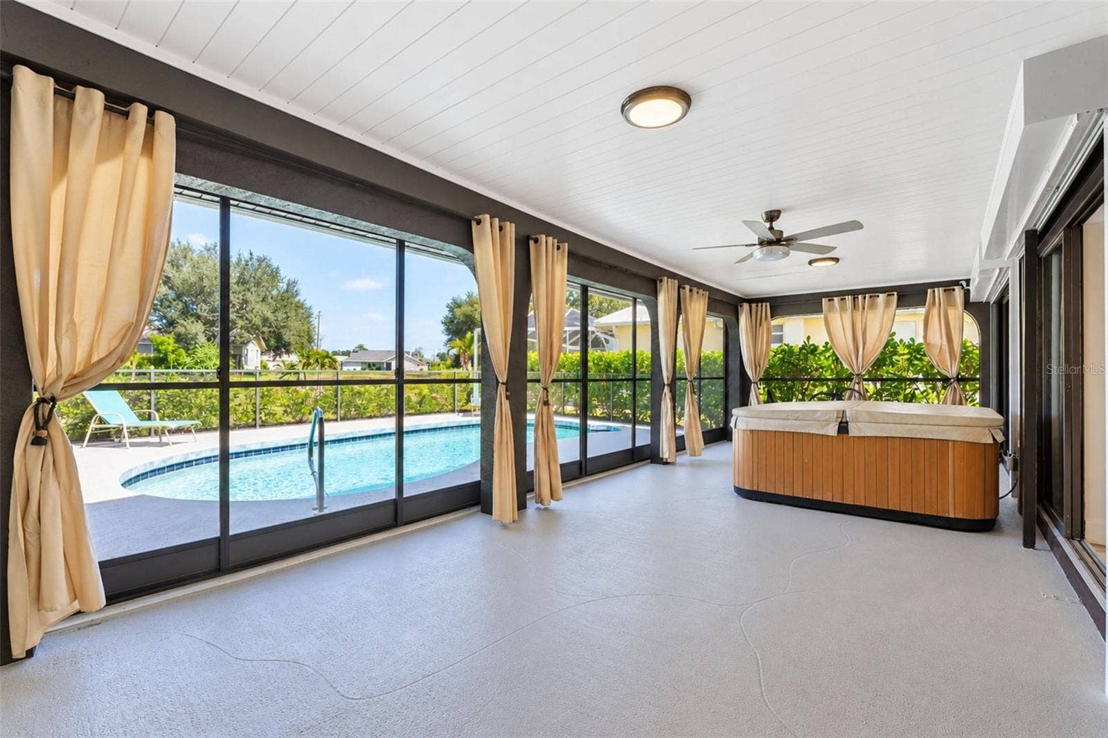 122 BUNKER ROAD, Rotonda West, FL 33947 Covered and screened lanai overlooking the pool and golf course.