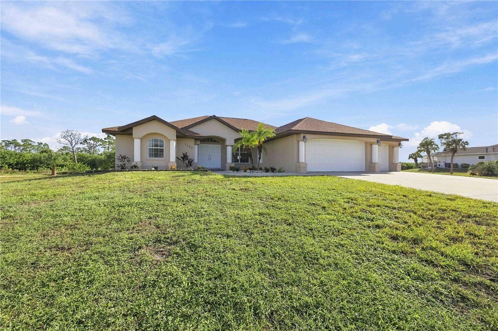 Front exterior and spacious front yard