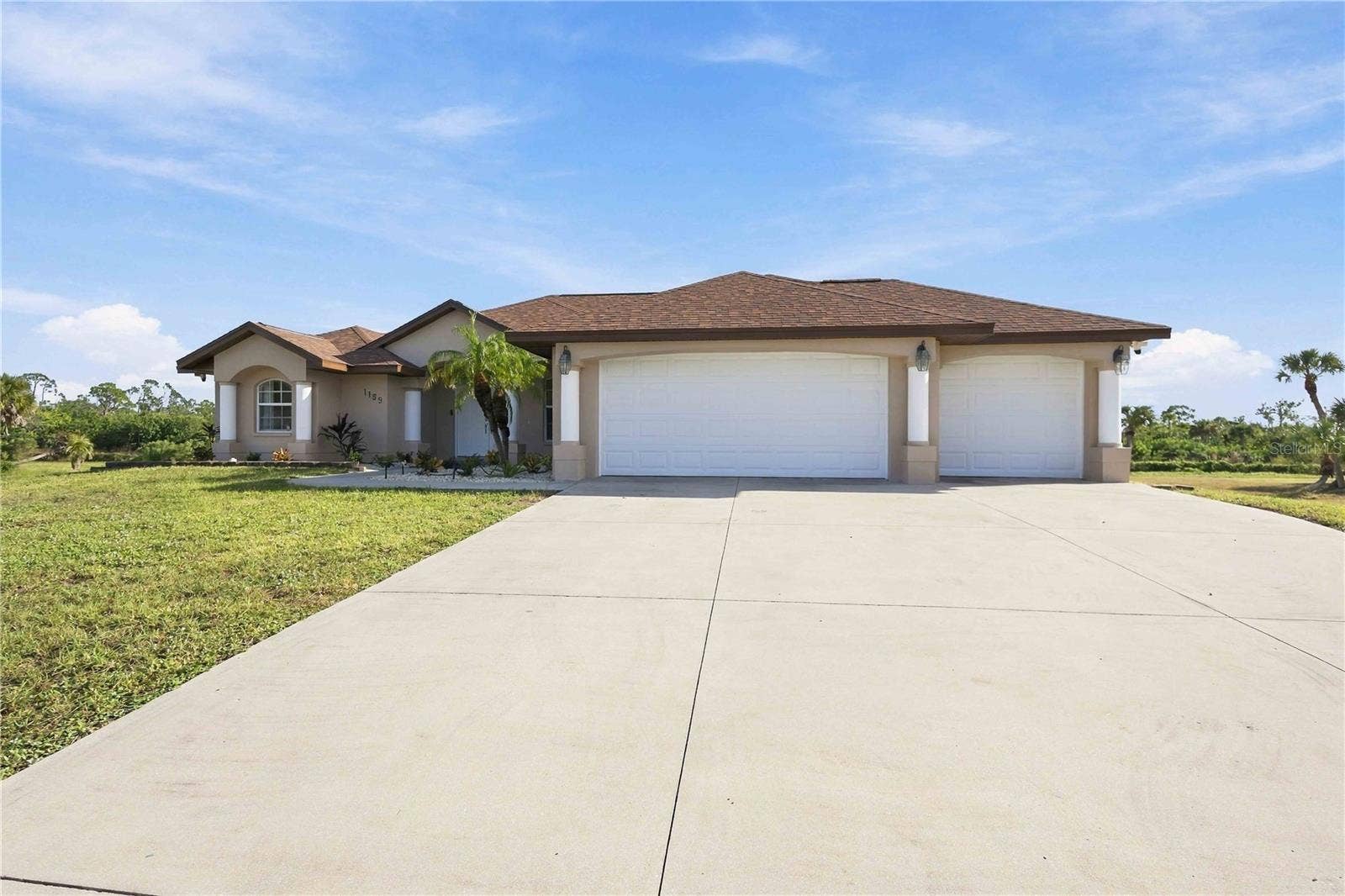 Front exterior with 3-car garage and wide driveway