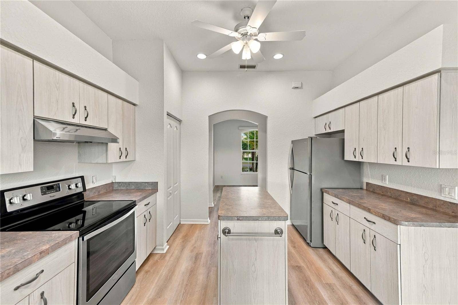 Kitchen with galley-style layout and stainless appliances