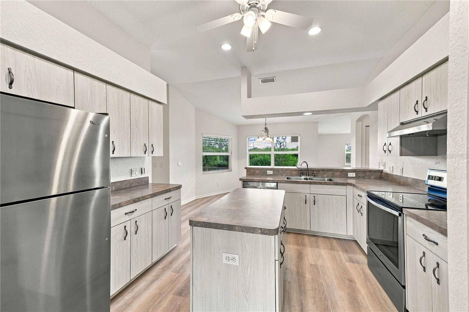 Kitchen with stainless refrigerator and ample cabinetry