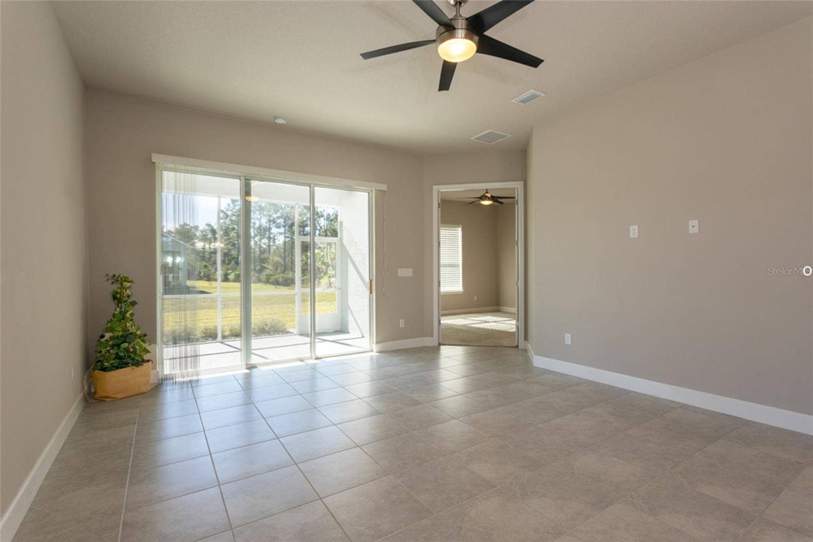 3 NEWHAVEN LANE, Ormond Beach, FL 32174 Living area looking towards lanai and primary bedroom