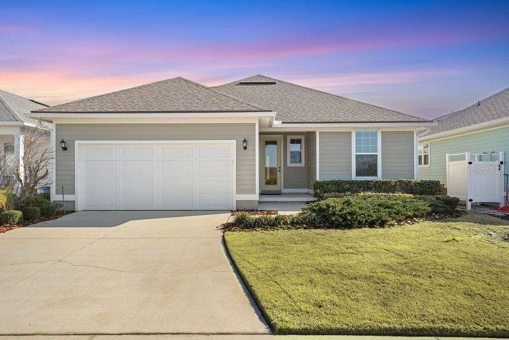 4 HIDDEN TREASURE DRIVE, Palm Coast, FL 32137 REAR OF HOME AND DRIVEWAY