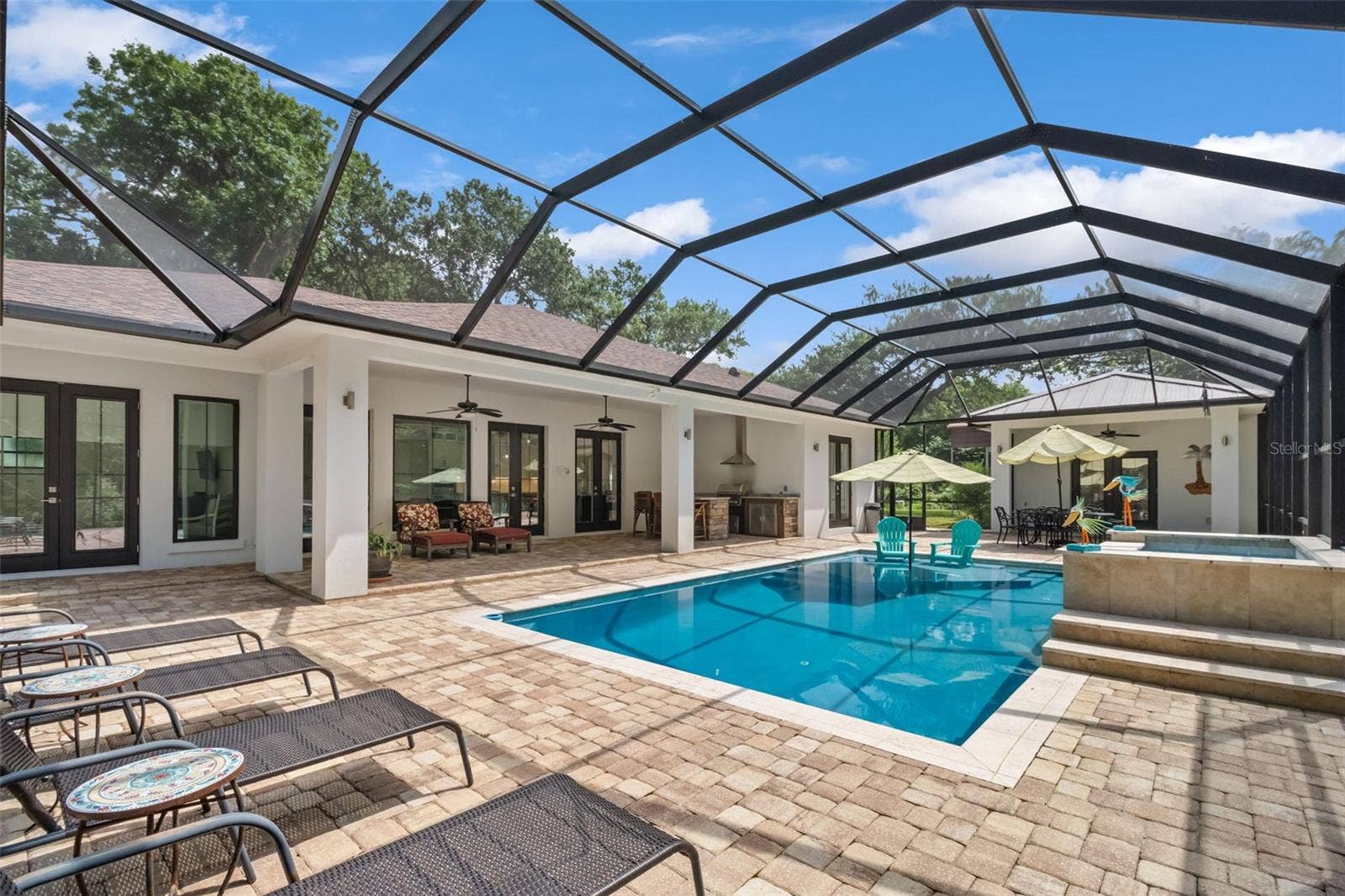 Outside paradise awaits with built in grilling station, refrigerators, sink and storage.