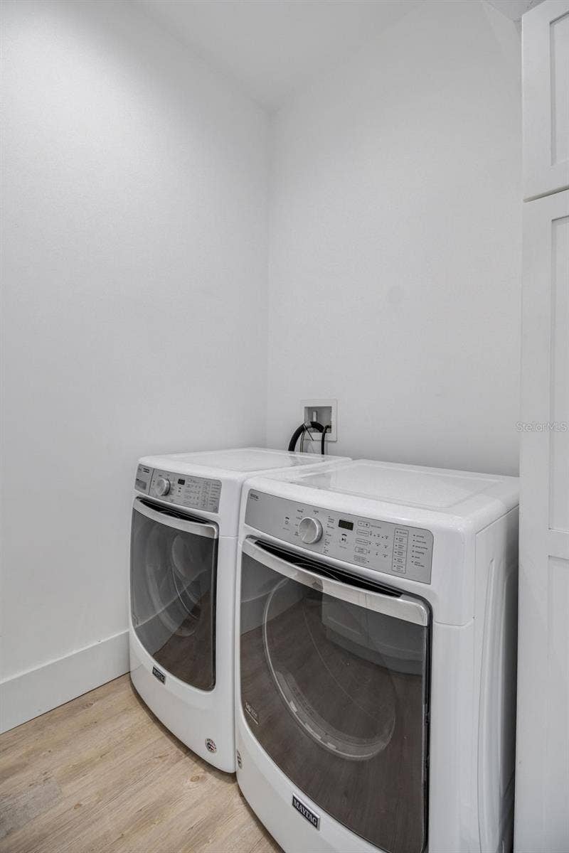 Generously sized laundry room designed for convenience