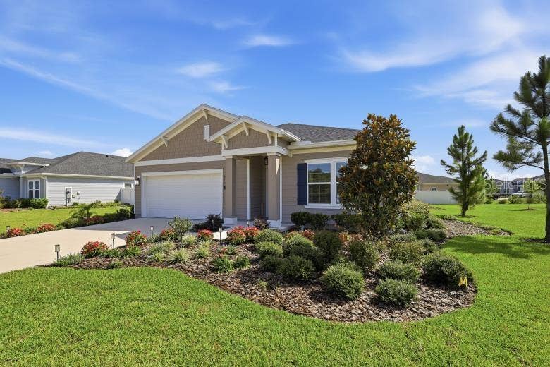 2110 RAGLAN CIRCLE, Ormond Beach, FL 32174 Lush green yard and beautiful flowers and landscaping greets you.