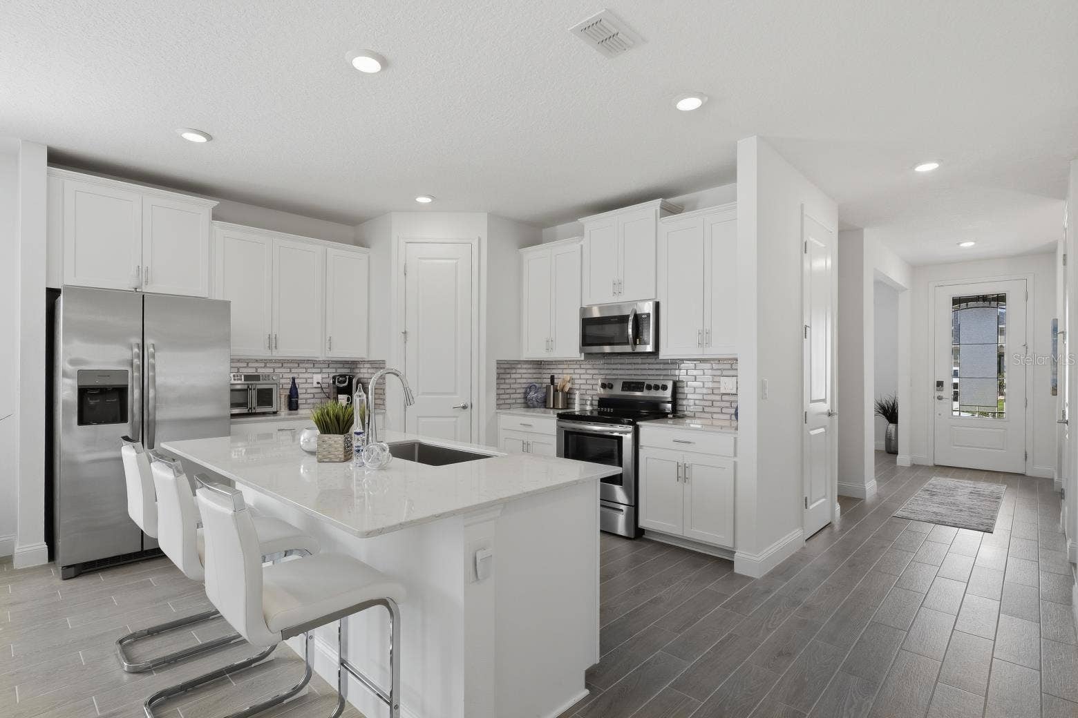 2110 RAGLAN CIRCLE, Ormond Beach, FL 32174 The kitchen features white shaker cabinets, stainless steel appliances and more!