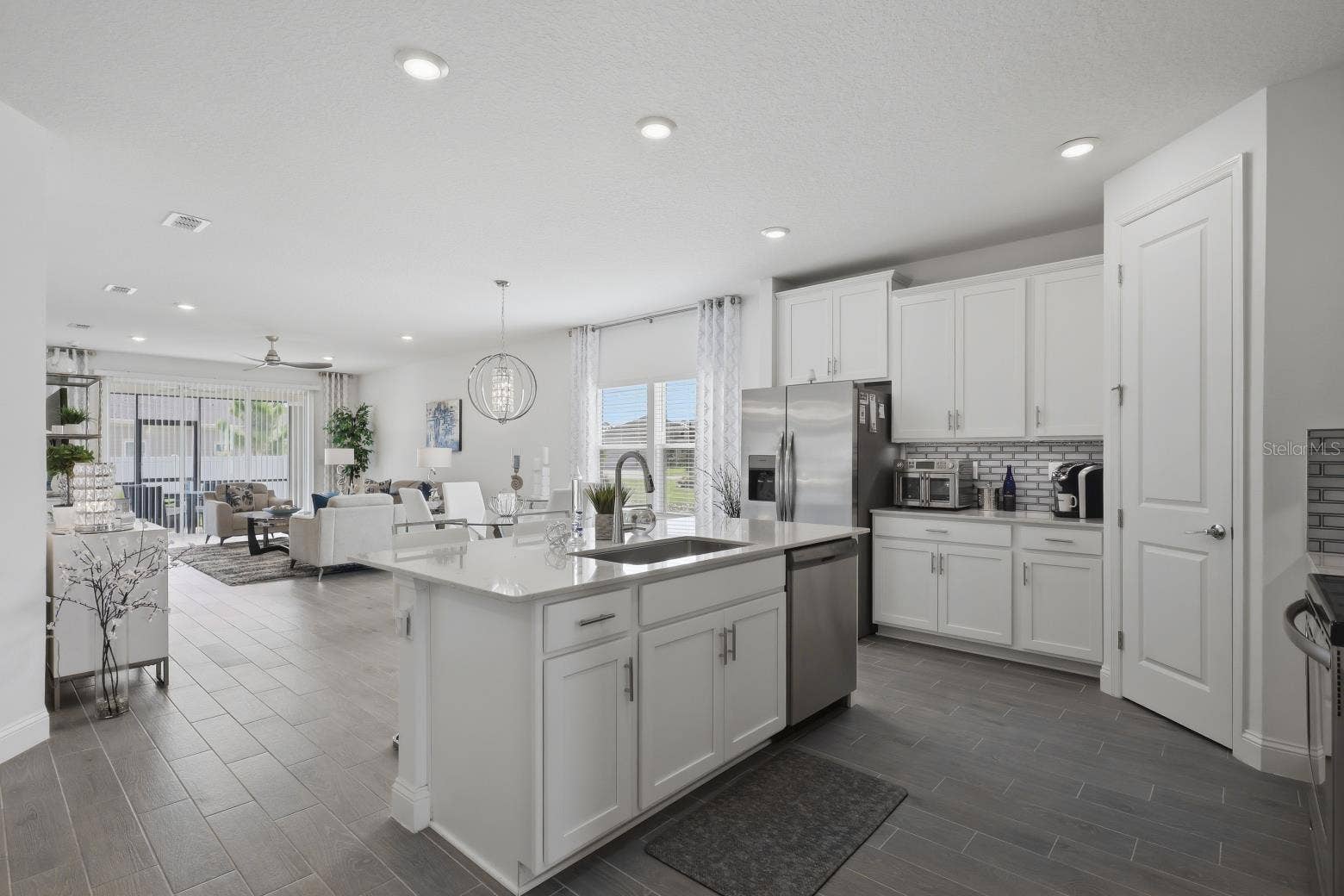 2110 RAGLAN CIRCLE, Ormond Beach, FL 32174 The open layout flows from the kitchen, past the dining area to the Great/Family Room.