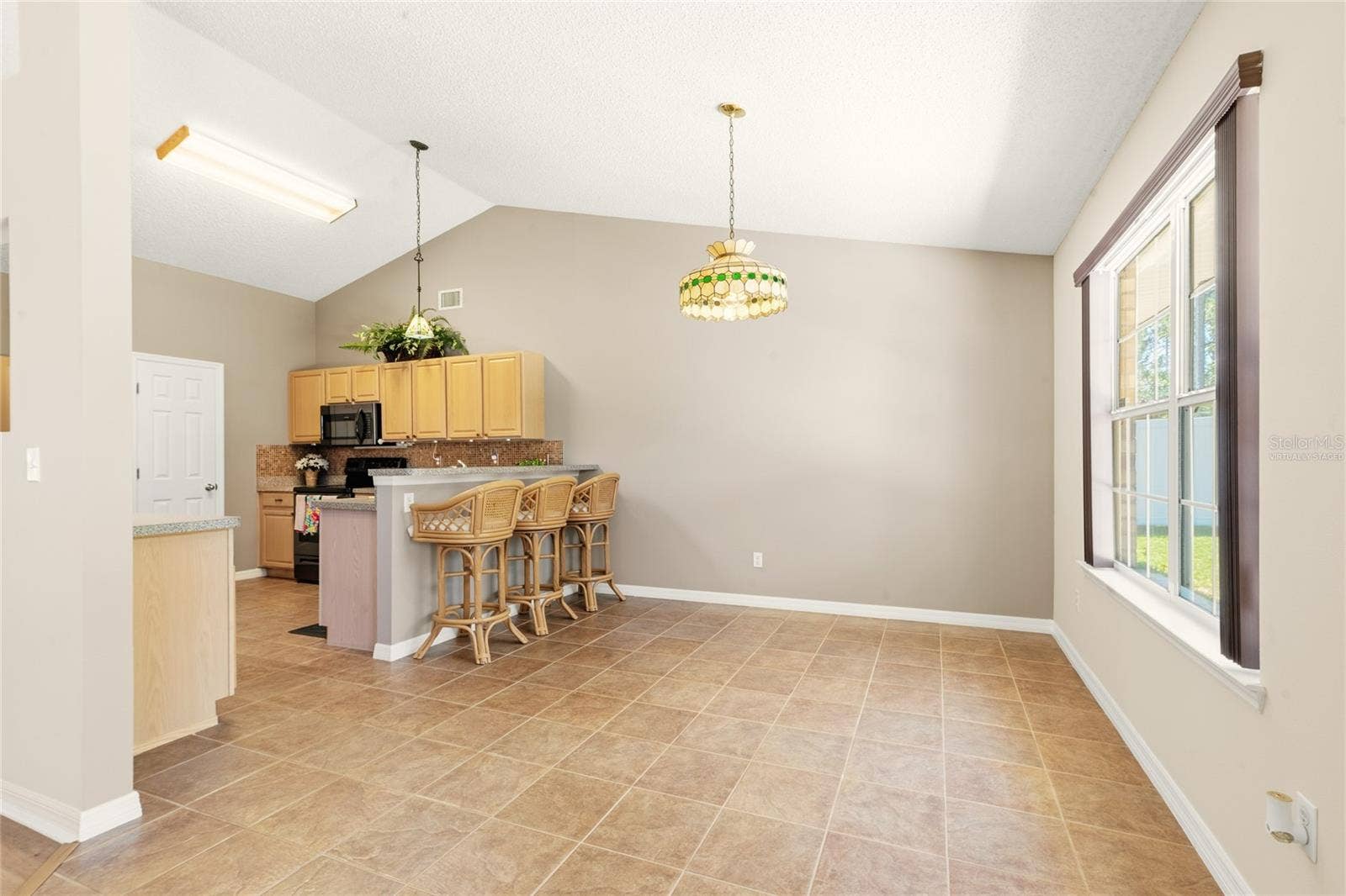 38 PRINCESS ROSE DRIVE, Palm Coast, FL 32164 Virtually Staged Breakfast Nook with a Roun d Table Option