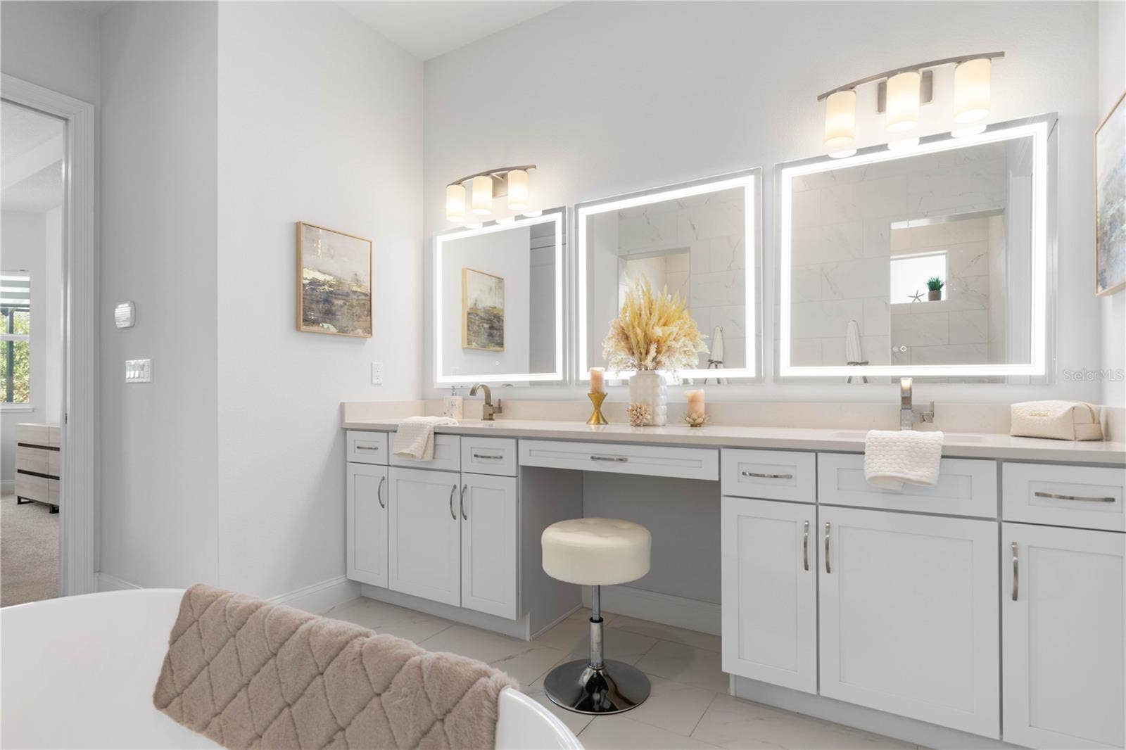 Dual vanities with sitting area and LED mirrors