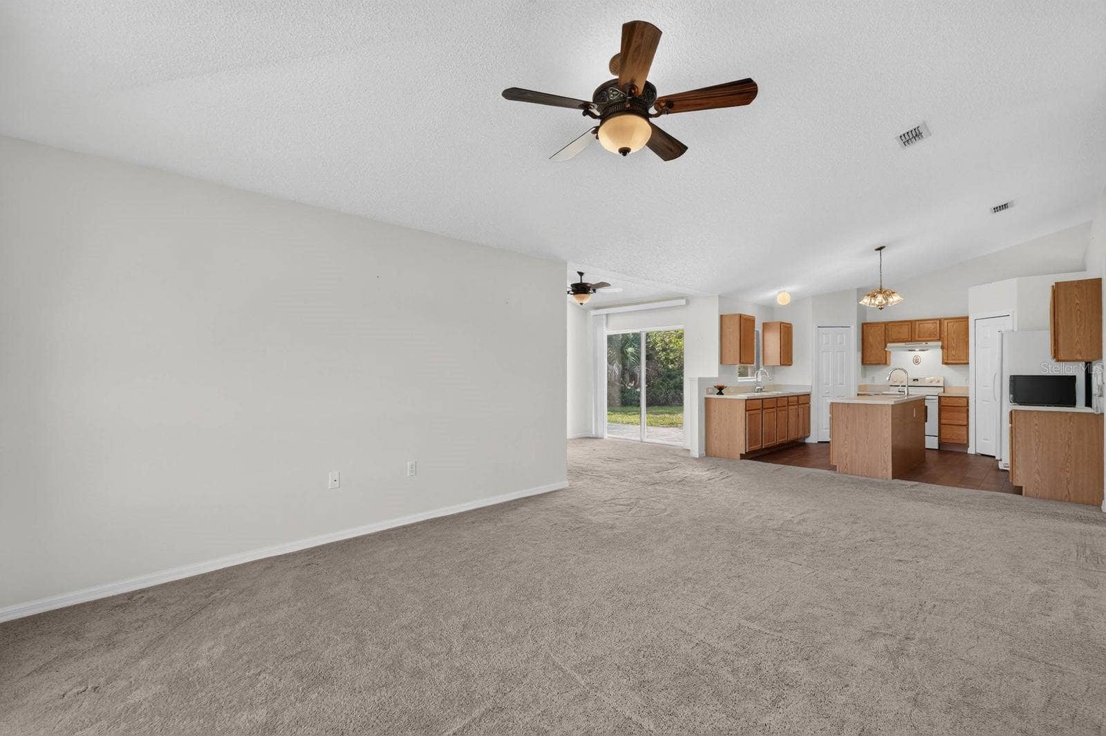 99 PICKERING DRIVE, Palm Coast, FL 32164 Family room looking towards the kitchen