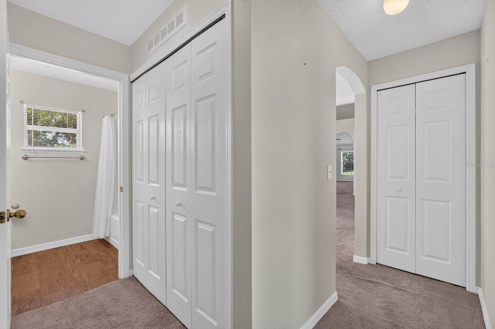 99 PICKERING DRIVE, Palm Coast, FL 32164 guest hallway with laundry closet and to the right down the hall the linen closet