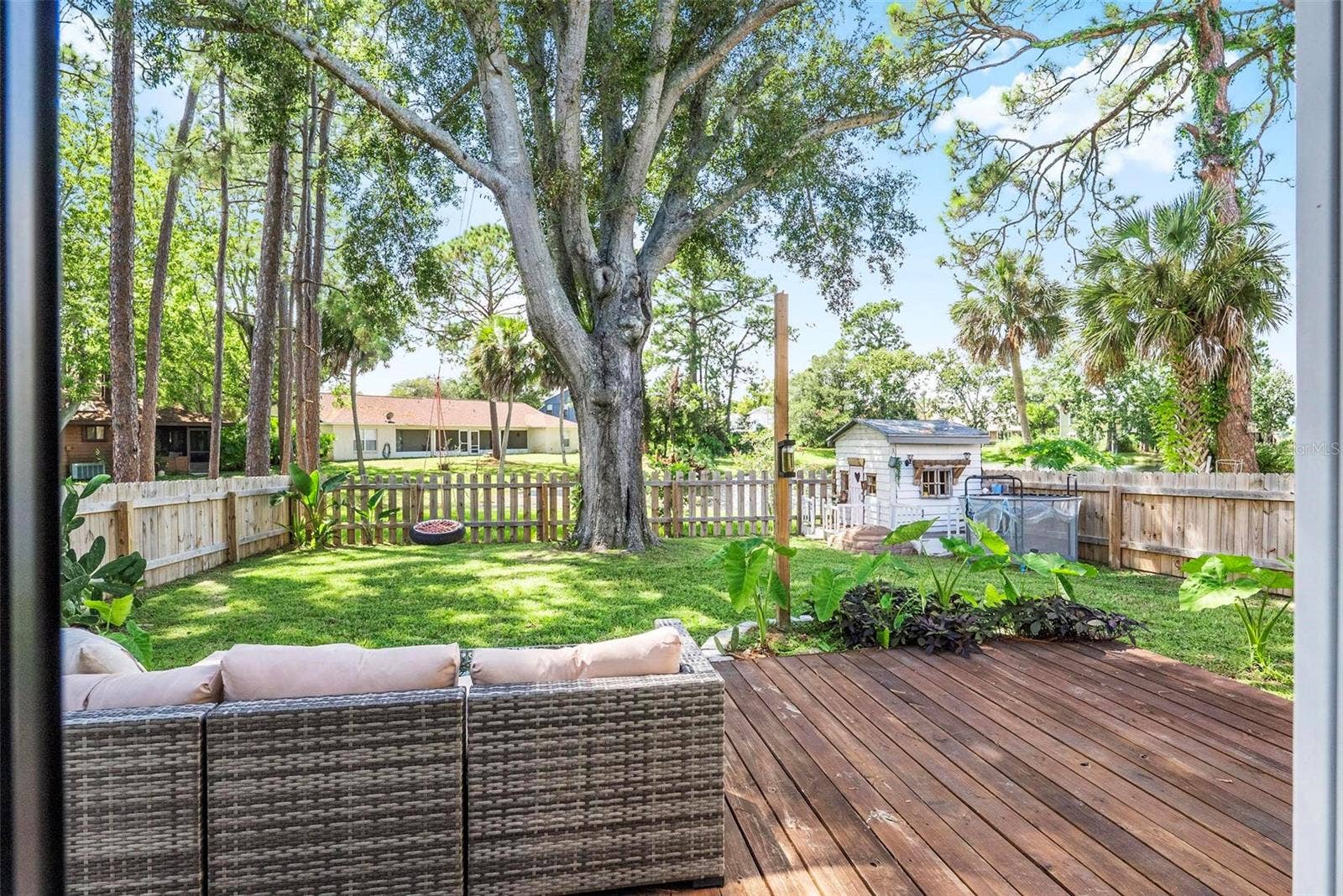 1110 MONTICELLO LANE, #1, Port Orange, FL 32129 Backyard with decking & tons of shade
