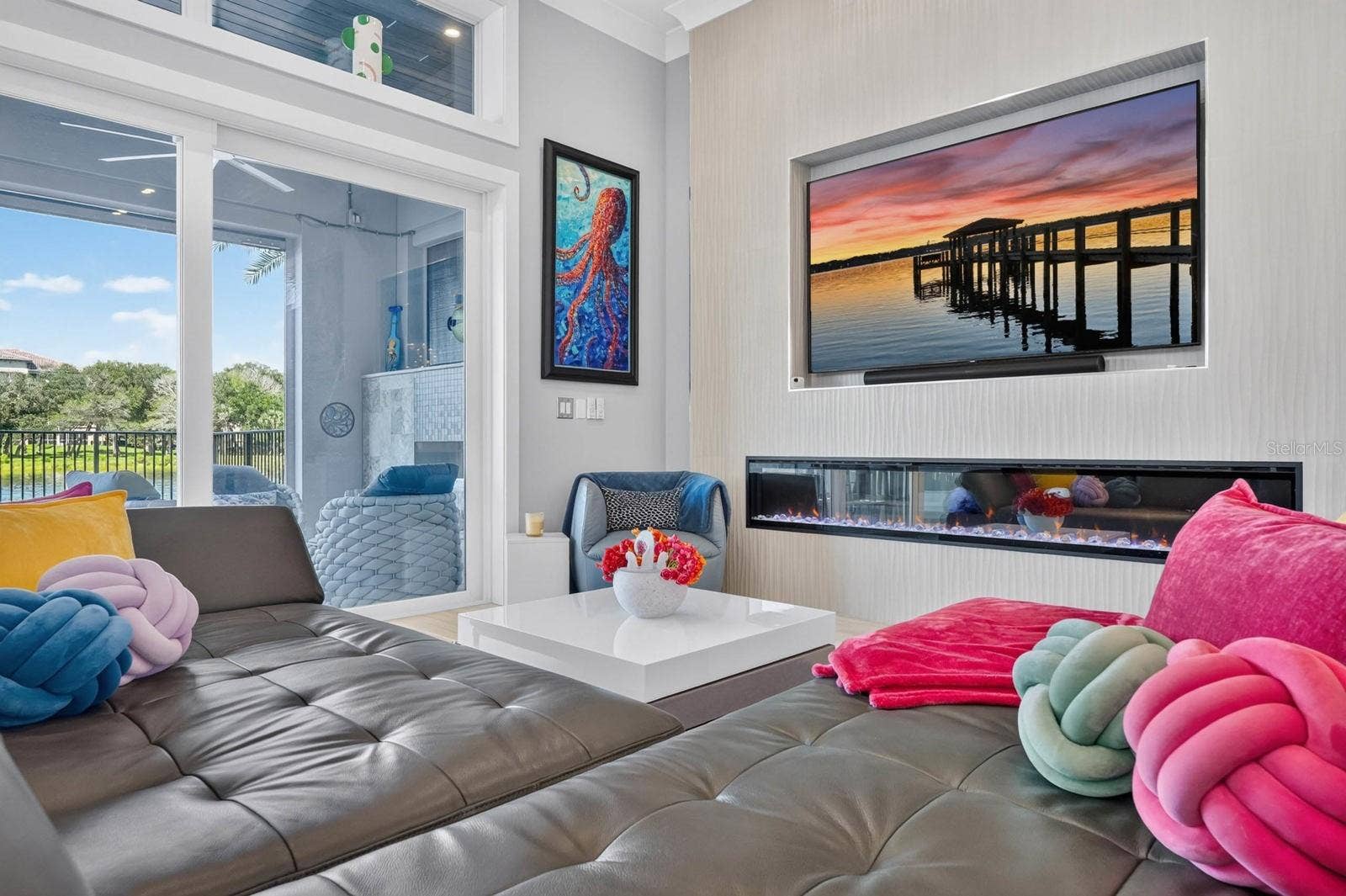 304 YACHT HARBOR DRIVE, Palm Coast, FL 32137 A dramatic linear fireplace anchors the living room, while walls of glass create an effortless connection to the covered lanai, pool and water beyond.