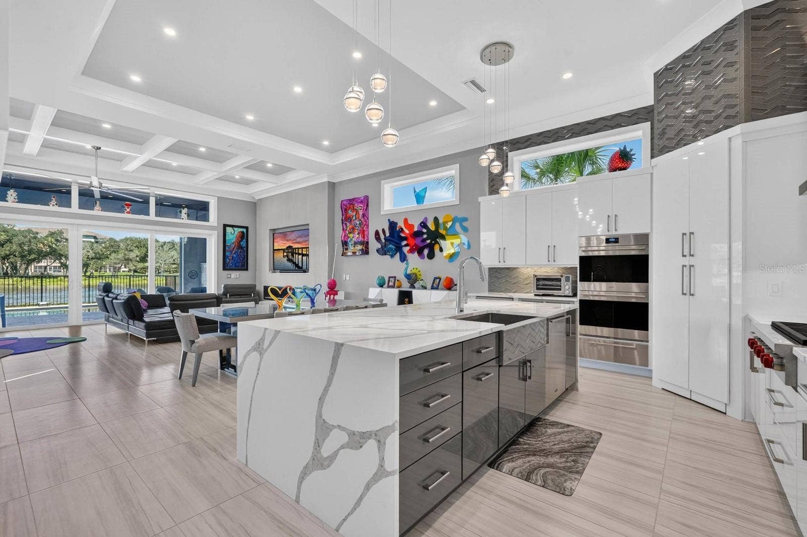 304 YACHT HARBOR DRIVE, Palm Coast, FL 32137 A kitchen built to be used and enjoyed. Statement quartz surfaces, custom cabinetry, premium appliances and designer lighting anchor the open-concept main living level, with the Intracoastal always in view.