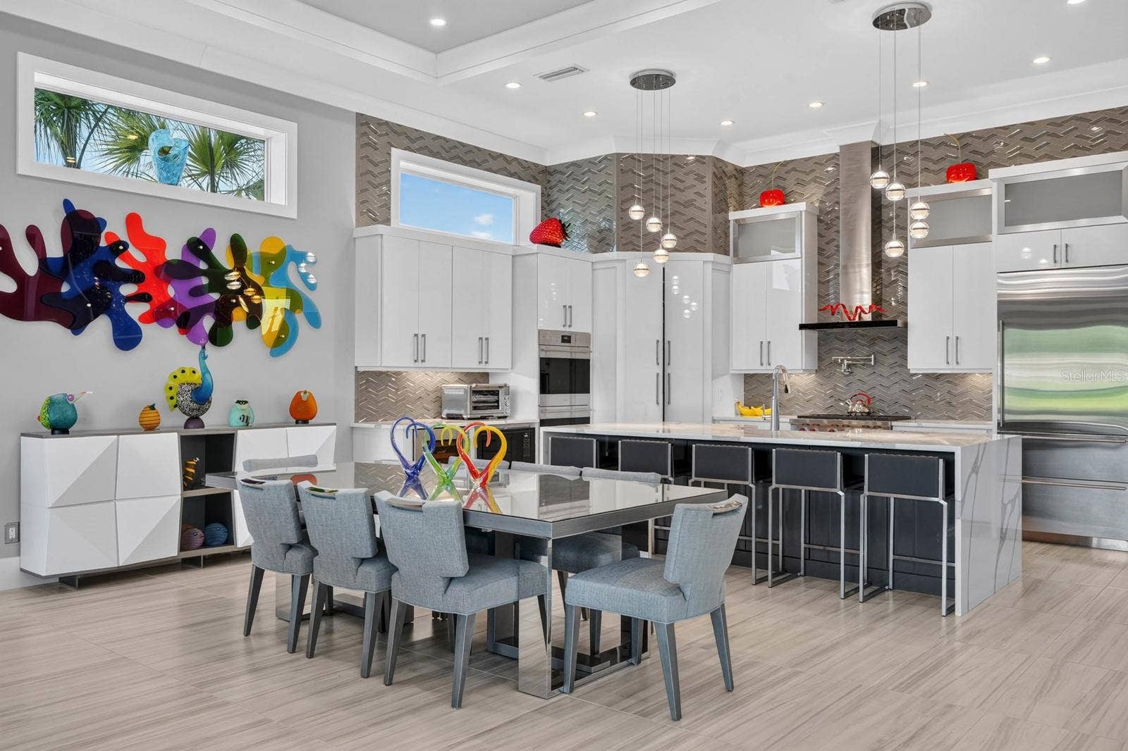 304 YACHT HARBOR DRIVE, Palm Coast, FL 32137 Designed to gather. An expansive open kitchen and dining area with soaring ceilings, designer lighting, custom cabinetry and professional-grade appliances creates a natural centerpiece for the main living level.