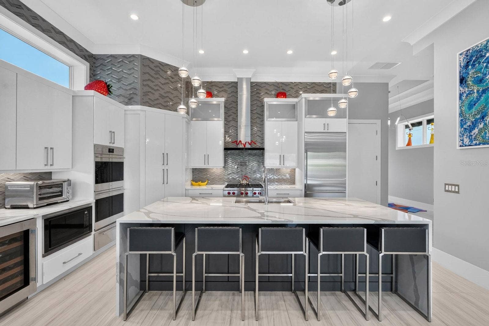 304 YACHT HARBOR DRIVE, Palm Coast, FL 32137 A kitchen designed without compromiseSub-Zero refrigeration, Wolf cooking, built-in wine storage, abundant cabinetry and dramatic ceiling-height finishes create a space that is both polished and highly functional.