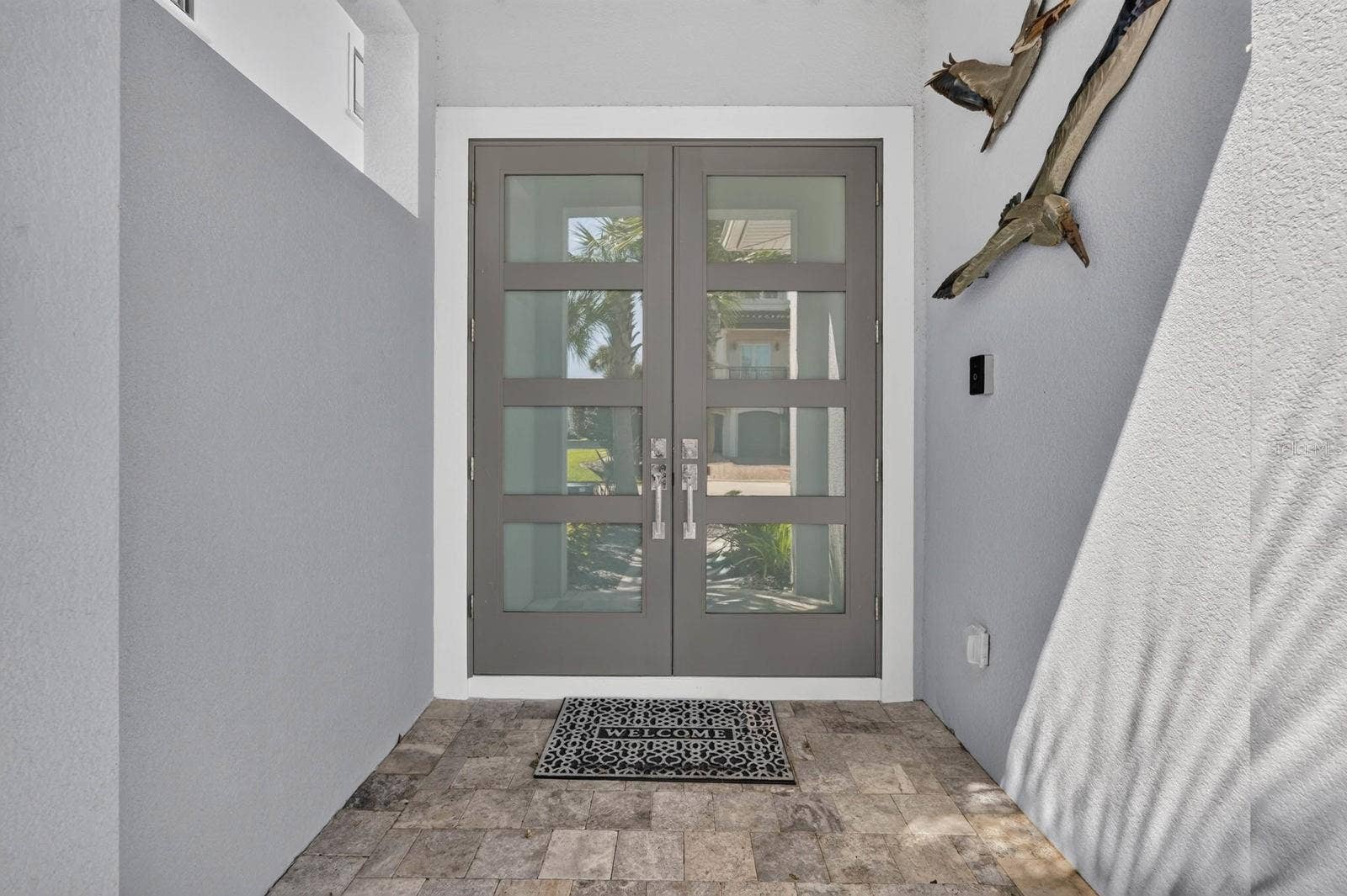 304 YACHT HARBOR DRIVE, Palm Coast, FL 32137 The details begin at the front door. Contemporary double-door entry sets the tone for the custom finishes found throughout the home.