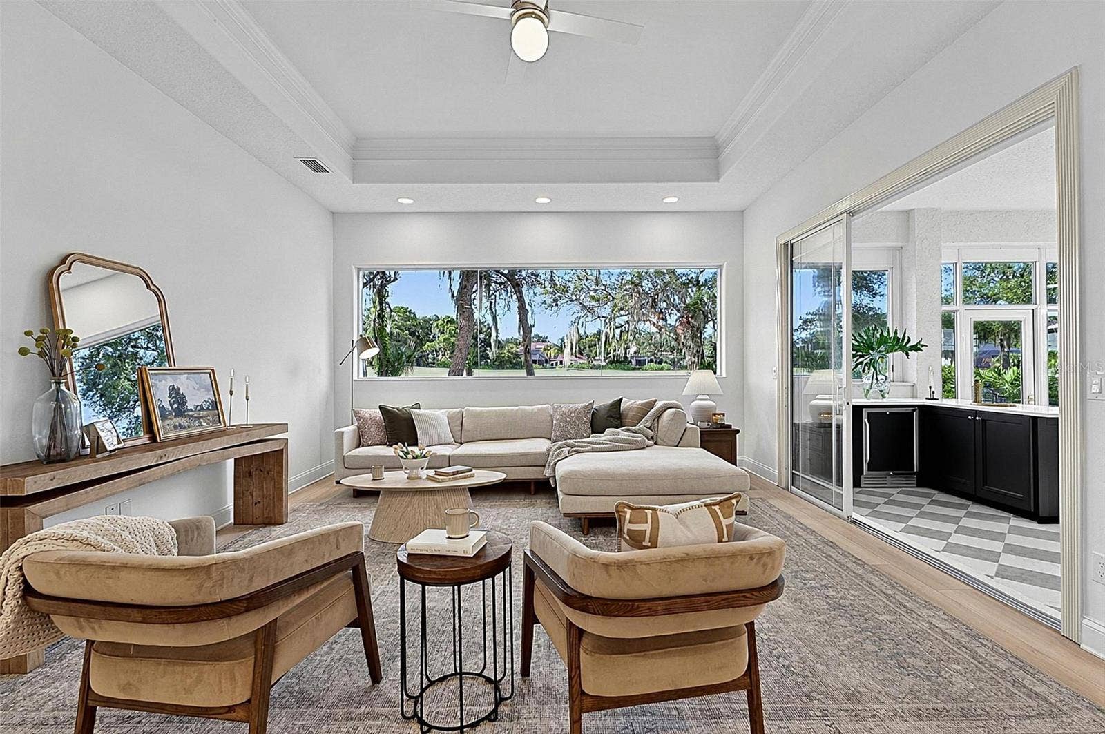 17 GRANDVIEW DRIVE, Palm Coast, FL 32137 Family room with Stunning views through wall of window looking out to backyard and golf course with triple sliders onto the solarium