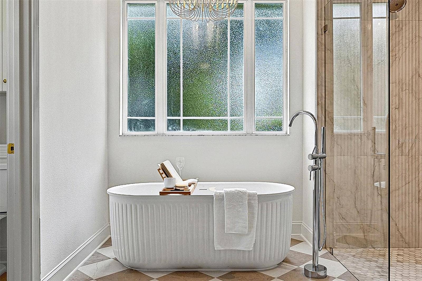 17 GRANDVIEW DRIVE, Palm Coast, FL 32137 Obsure Large window brings in soft lighting into the free standing tub and tiled stand up shower