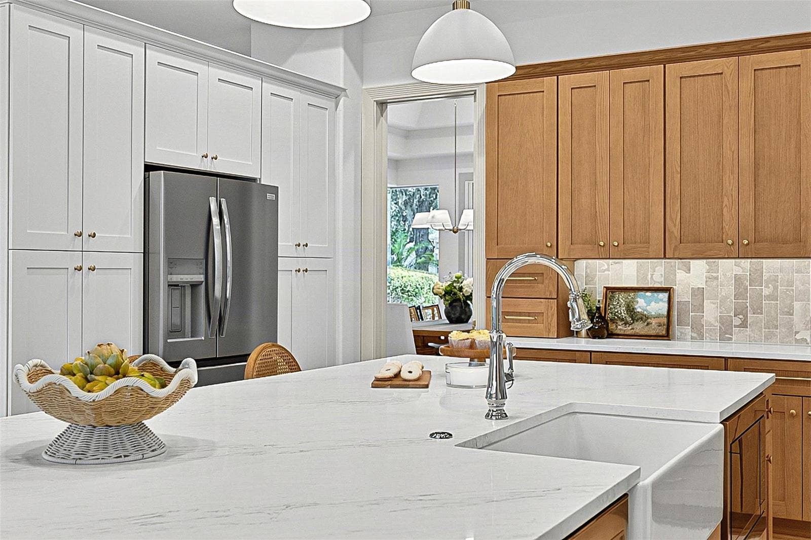 17 GRANDVIEW DRIVE, Palm Coast, FL 32137 Kitchen Island with farm sink, showing refrigerator with wall of pantry cabinets