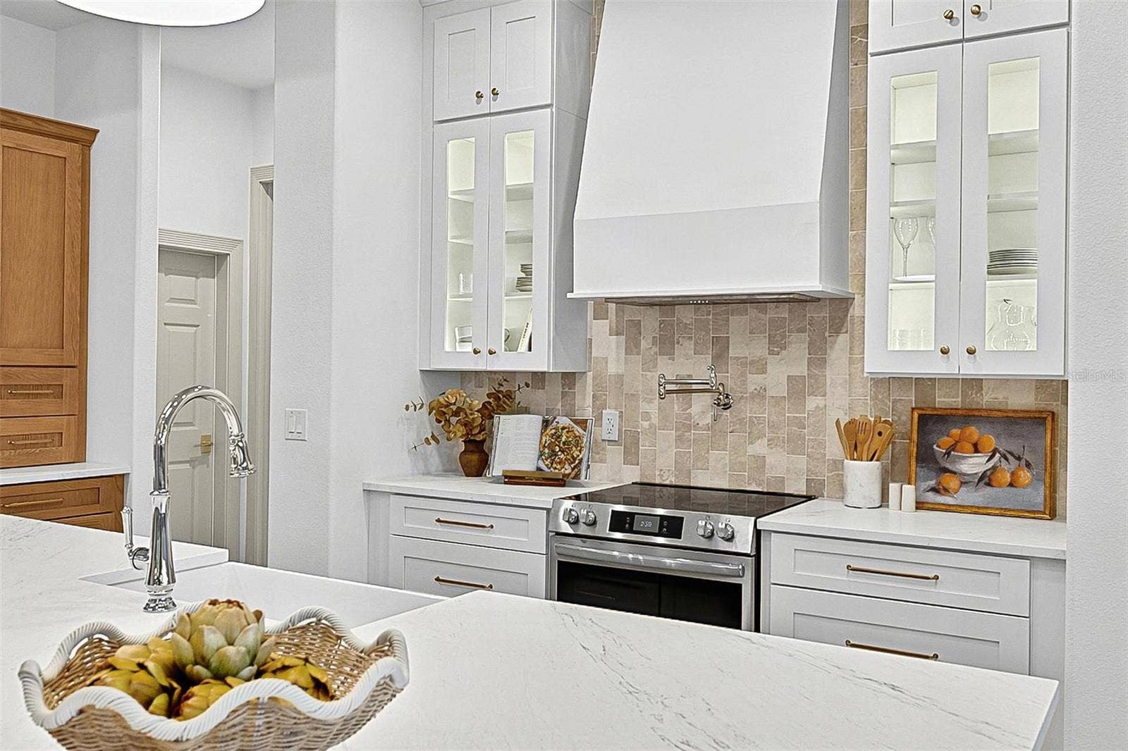 17 GRANDVIEW DRIVE, Palm Coast, FL 32137 Elegant Centerpiece Kitchen Island with crafted wall of tile and lighted window cabinets